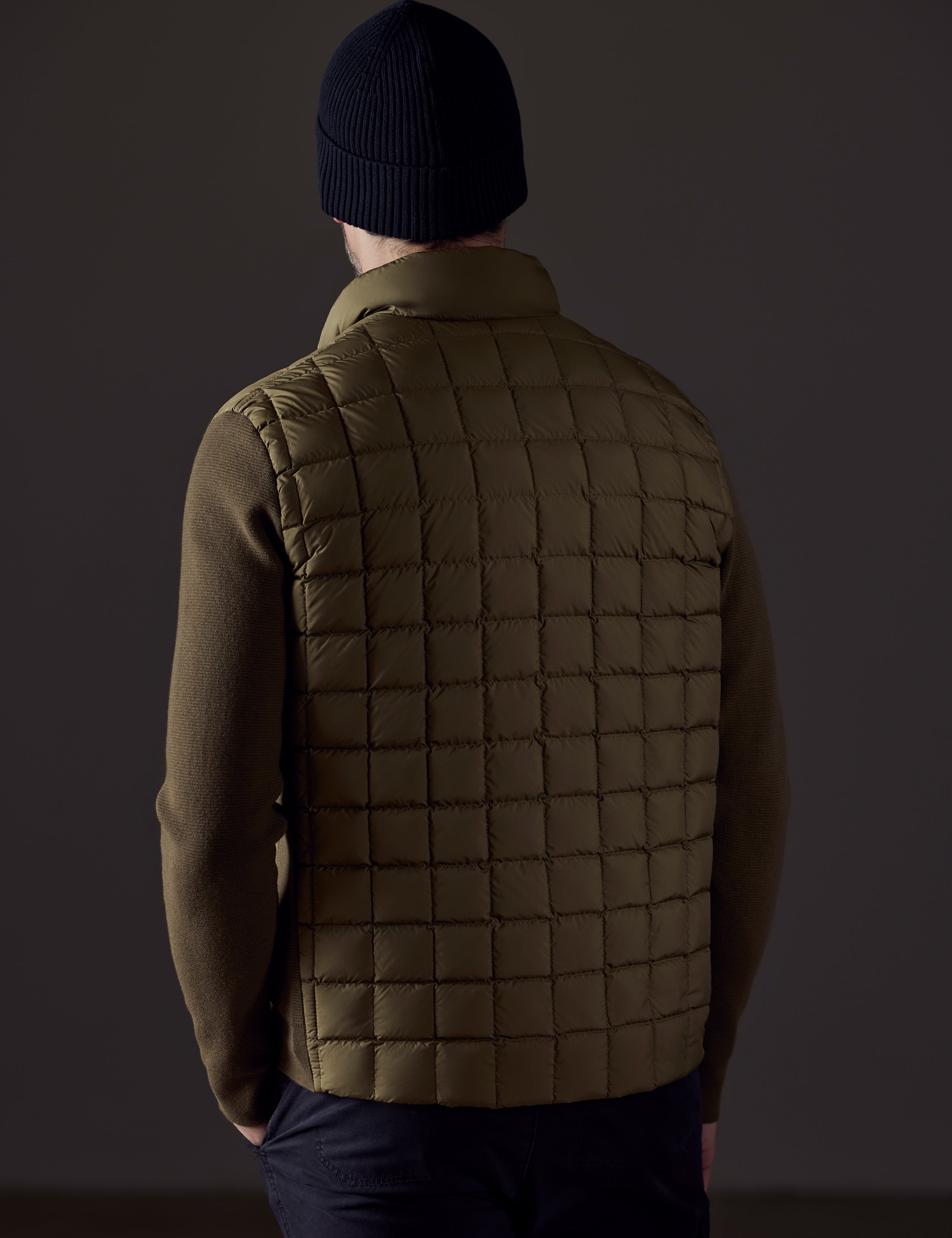 Rear body view of man wearing Phase Full-Zip in Command Green from AETHER Apparel.
