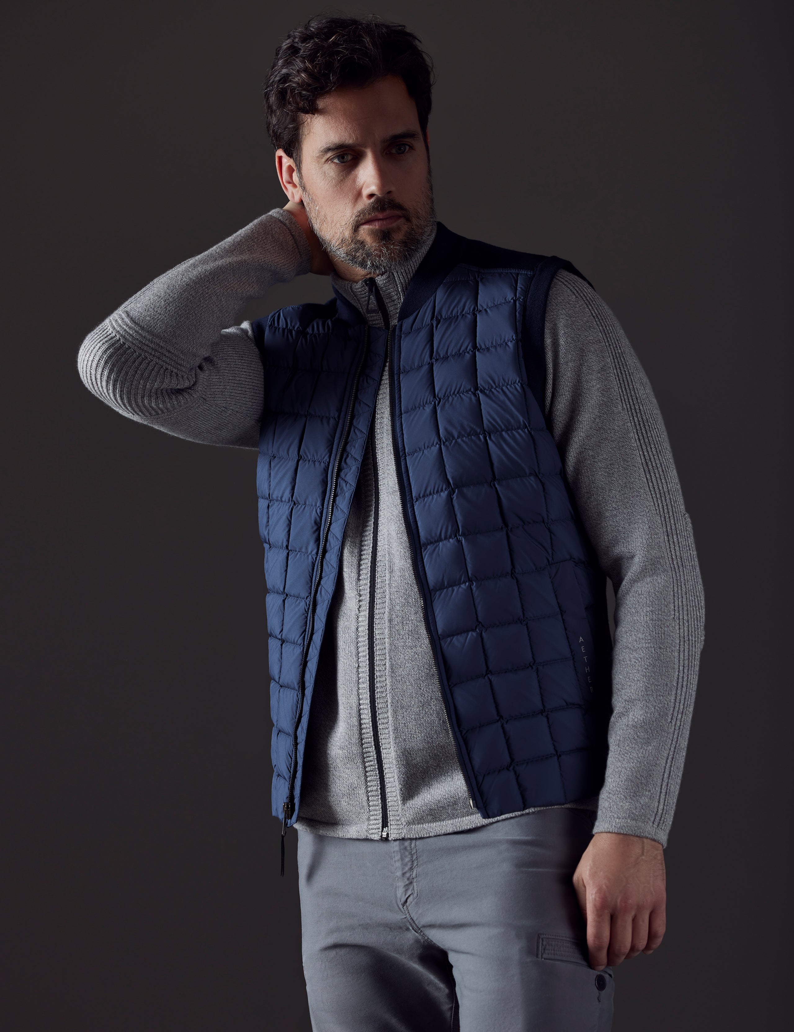 Front body view of man wearing Phase Vest in Total Eclipse dark blue from AETHER Apparel.