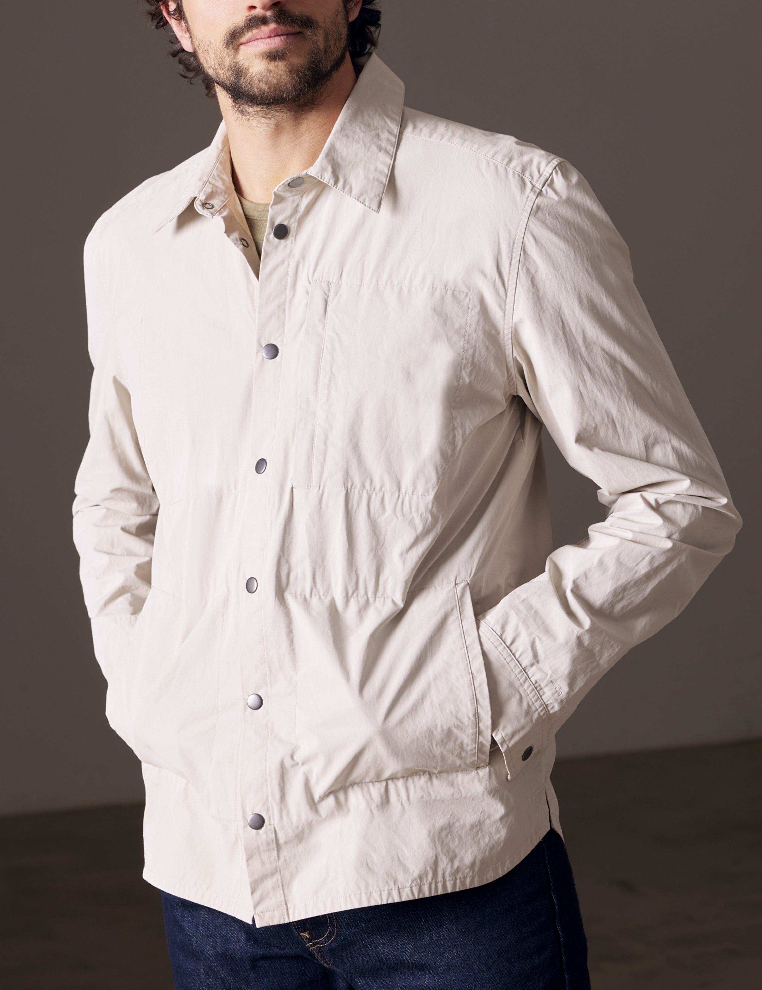 Front body view of man wearing Pine Shacket in Bone white from AETHER Apparel.