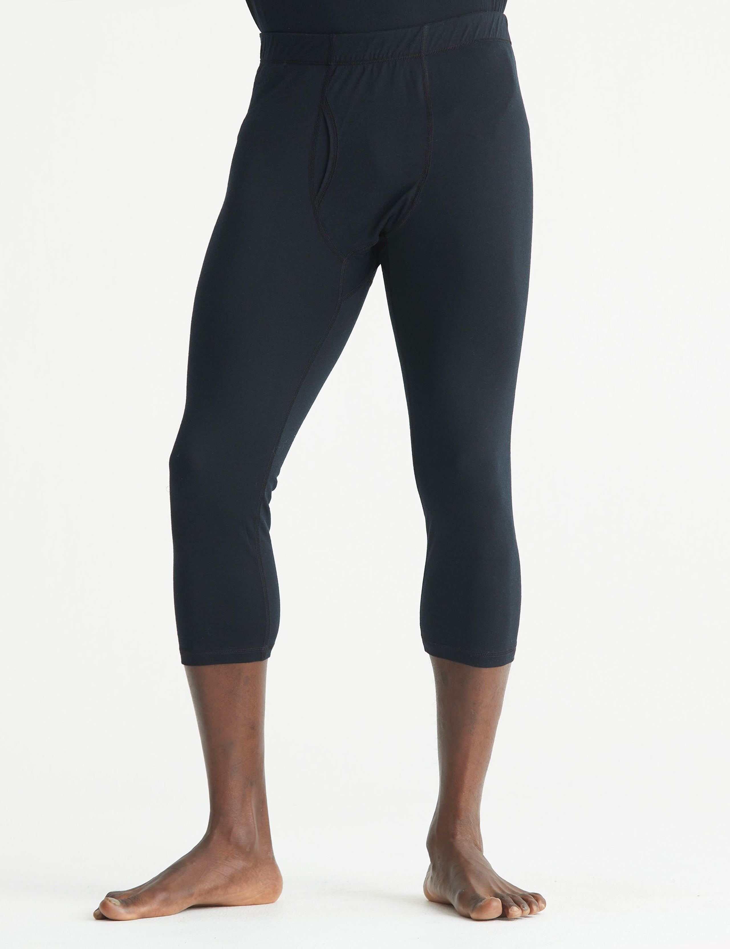 Front lower body view of man wearing Premium Merino Base Layer 3/4 Pant in Jet Black from AETHER Apparel.