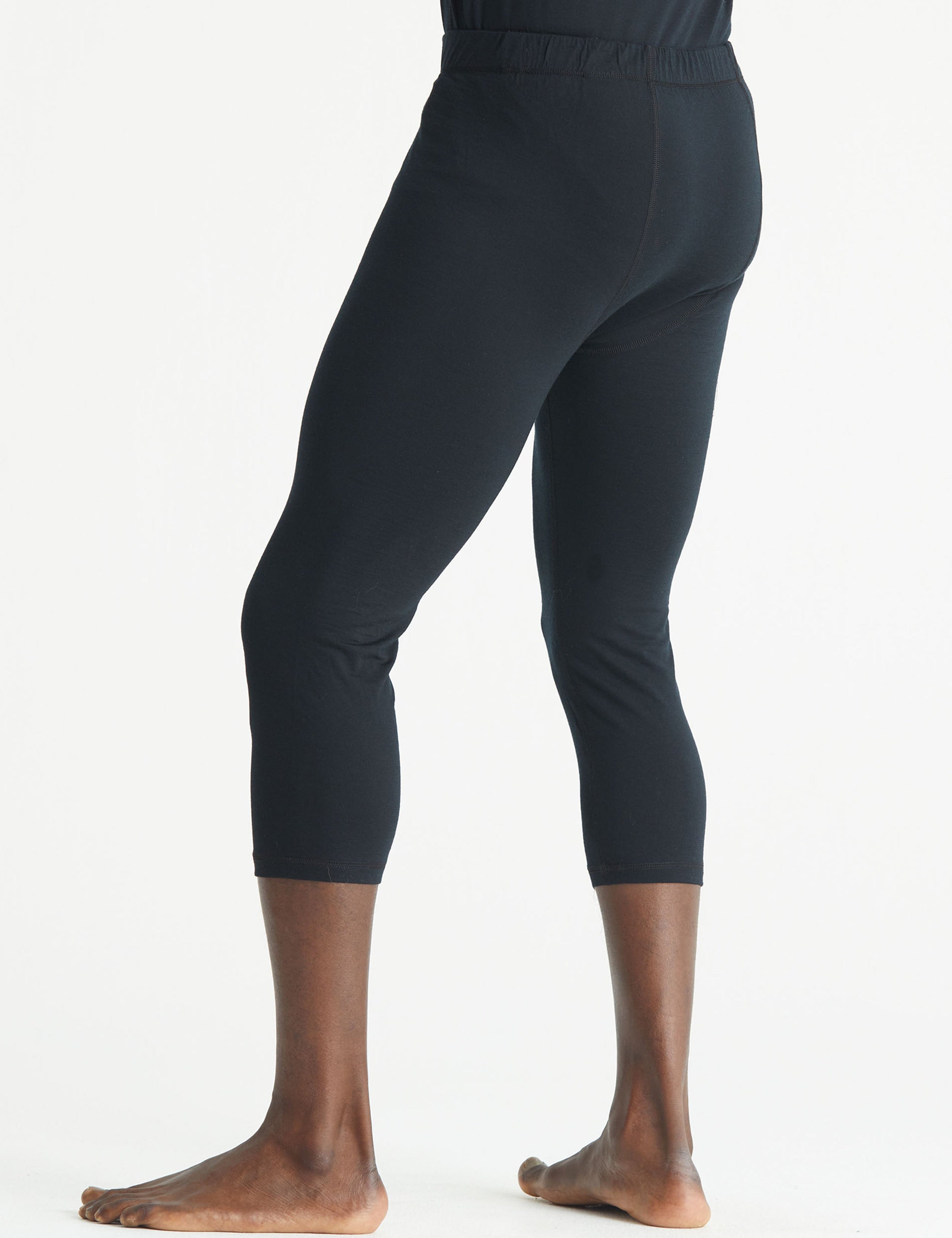 Rear 3/4 lower body view of man wearing Premium Merino Base Layer 3/4 Pant in Jet Black from AETHER Apparel.