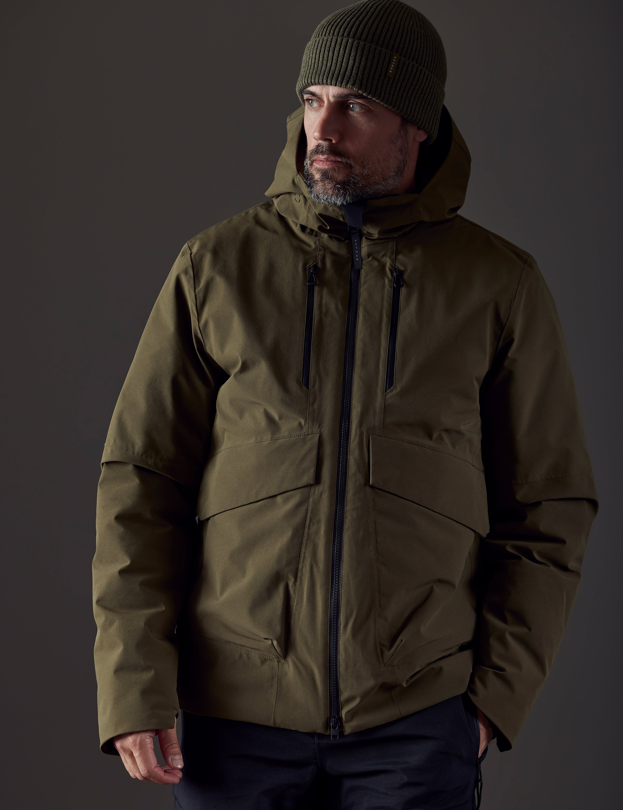 Front body view of man wearing Silverton Down Jacket in Command Green from AETHER Apparel.