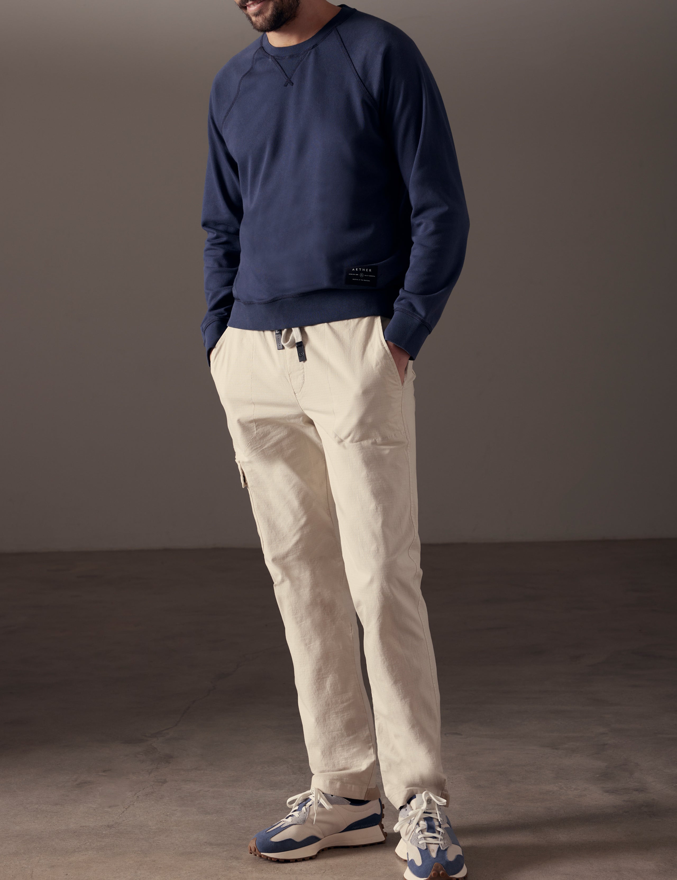 Front 3/4 full-body view of man wearing Solstice Lightweight Crew in Total Eclipse dark blue from AETHER Apparel.