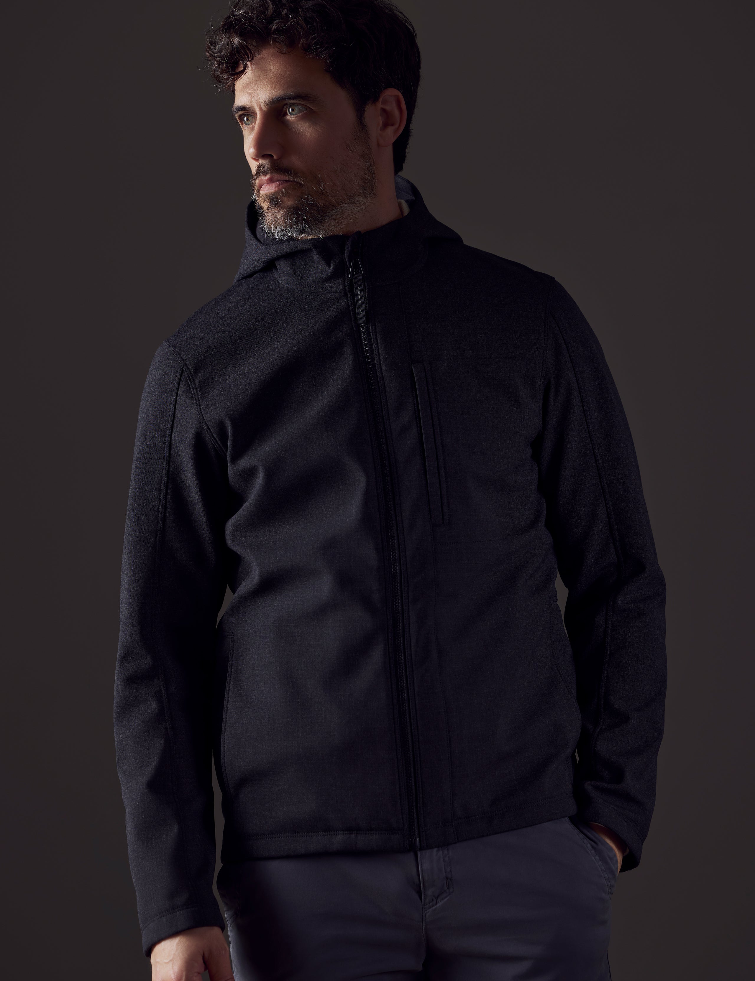 Front body view of man wearing Stanton Technical Jacket in Charcoal Heather from AETHER Apparel.