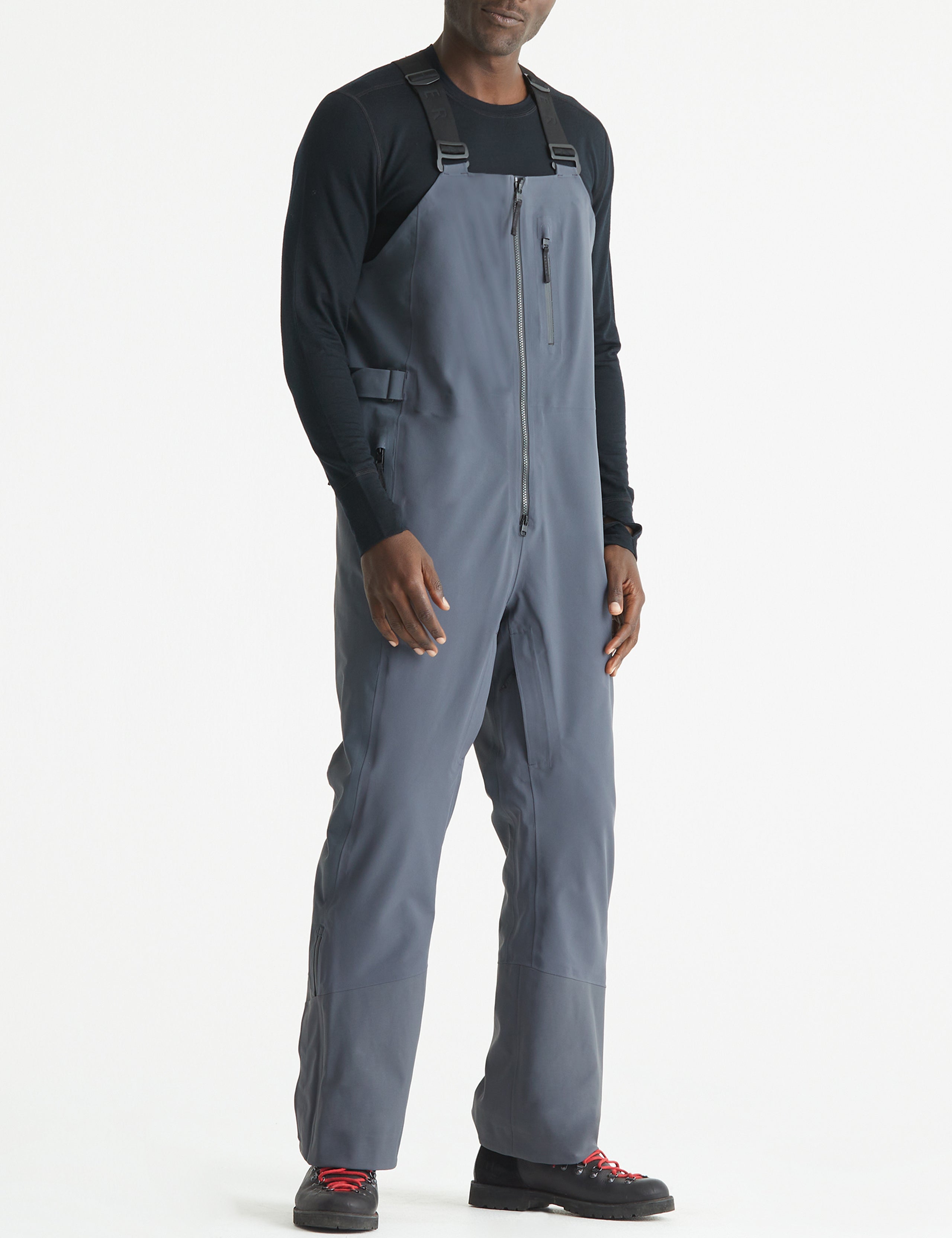 Front angled full-body view of man wearing Stealth Snow Bib in Graphite from AETHER Apparel.