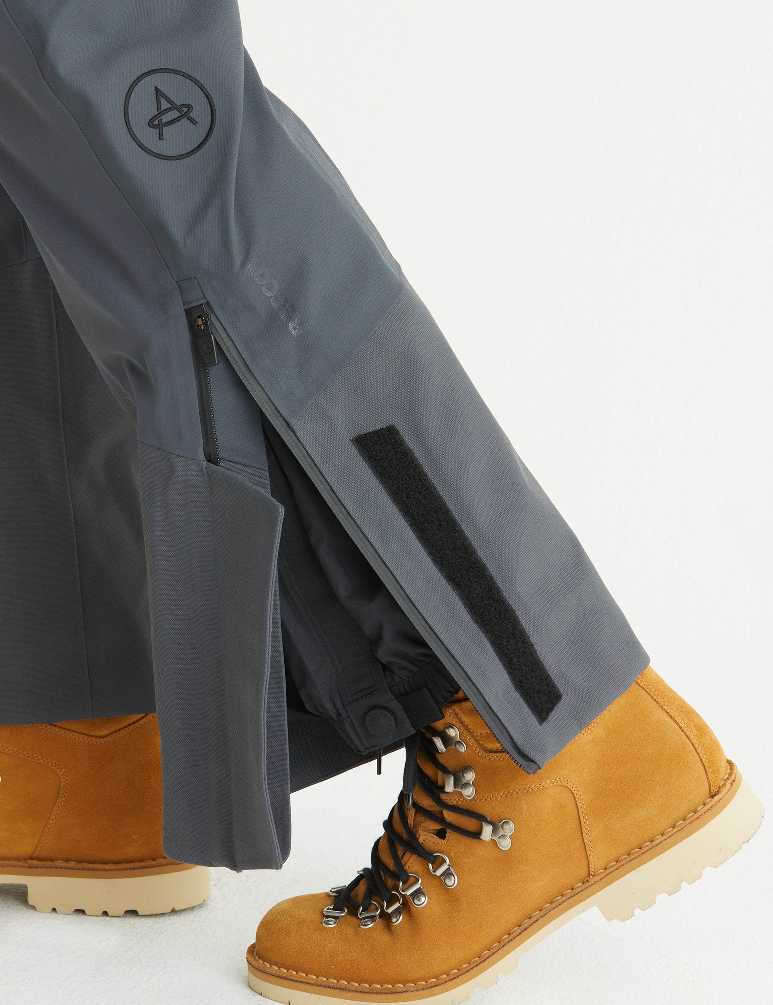 Closeup detailed view of zippered leg cuff opening on Stealth Snow Bib in Graphite from AETHER Apparel.