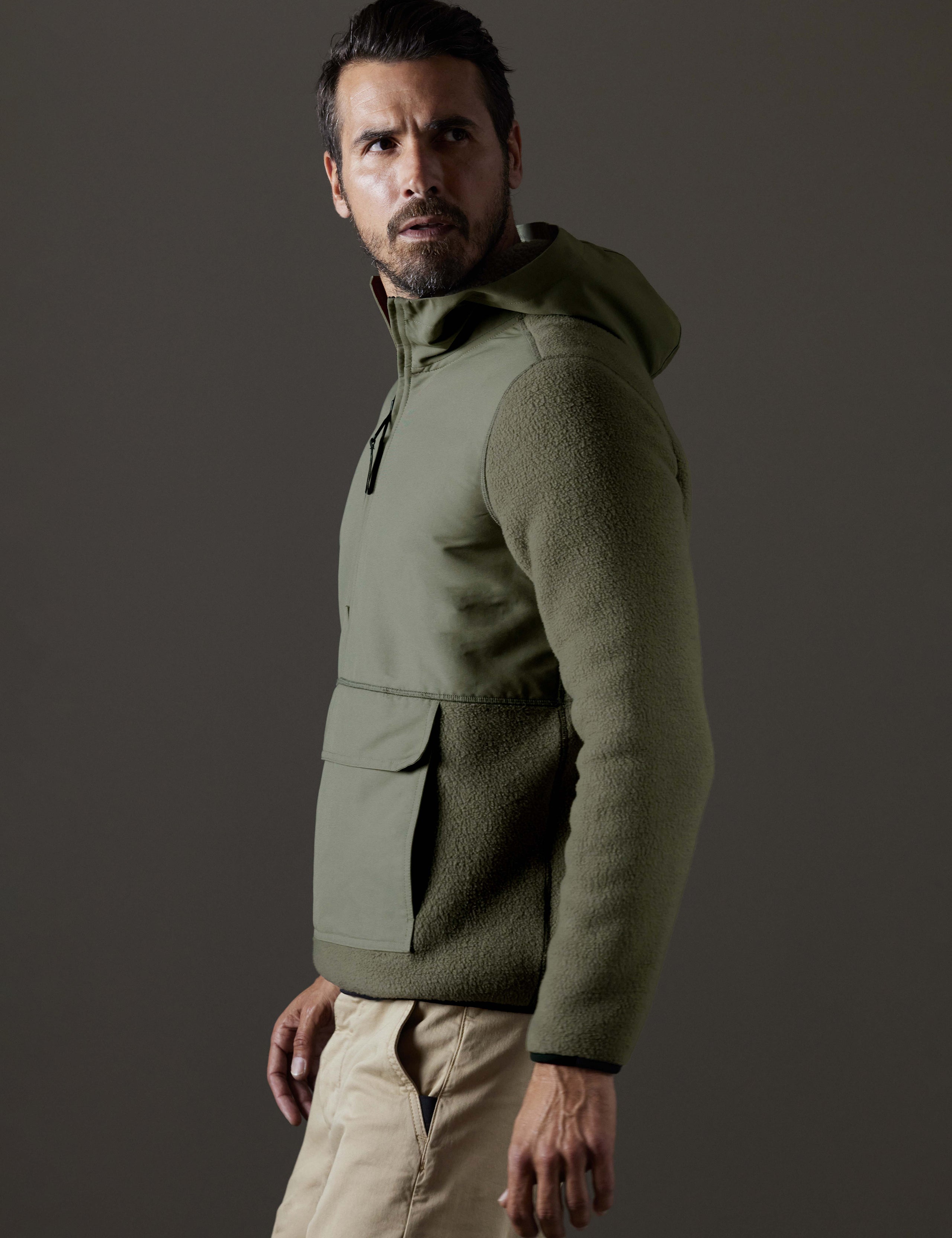 Side profile body view of man wearing Walsh Hooded Anorak in Fern Green from AETHER Apparel.