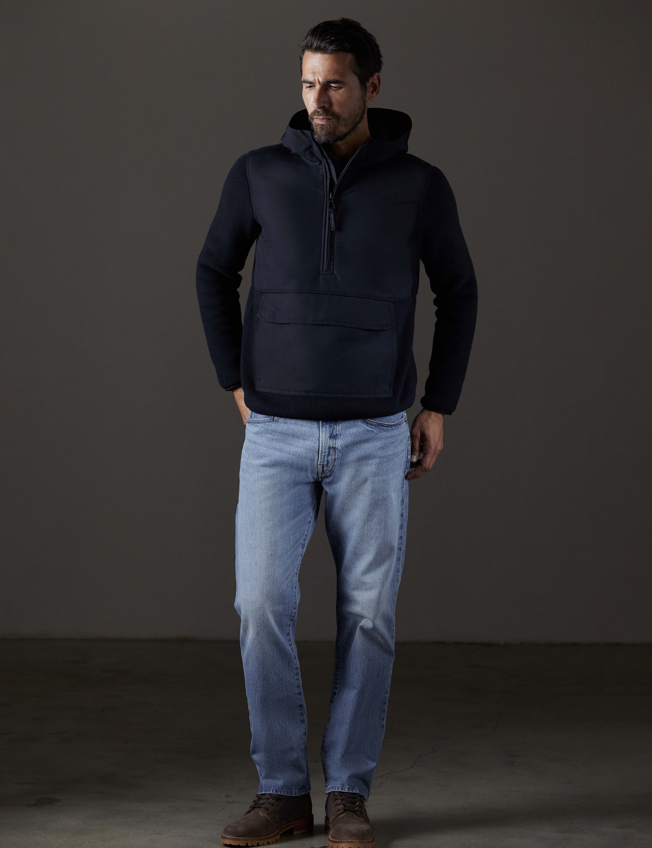 Front full-body view of man wearing Walsh Hooded Anorak in Onyx Black from AETHER Apparel.