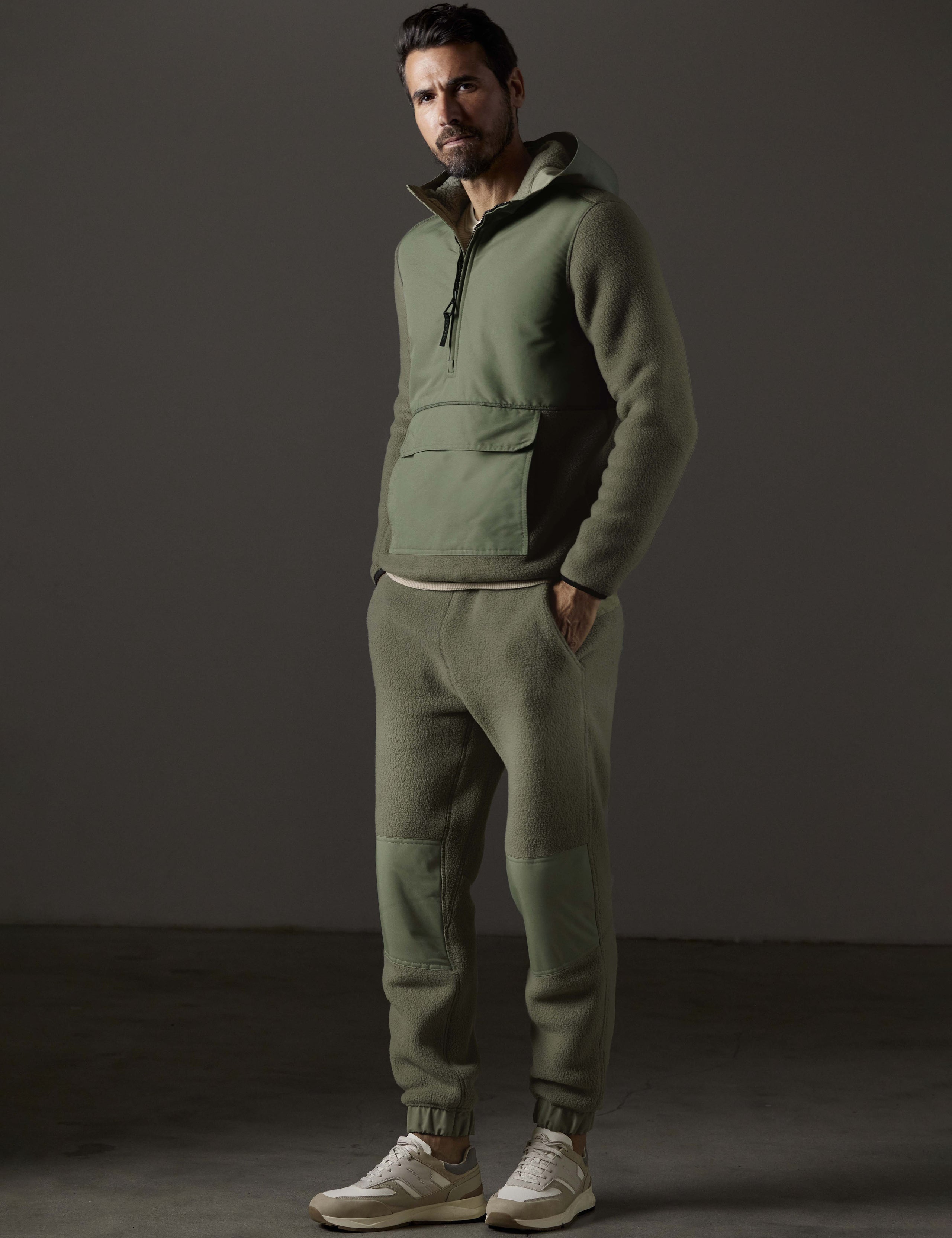 Front 3/4 full-body view of man wearing Walsh Pant in Fern Green from AETHER Apparel.