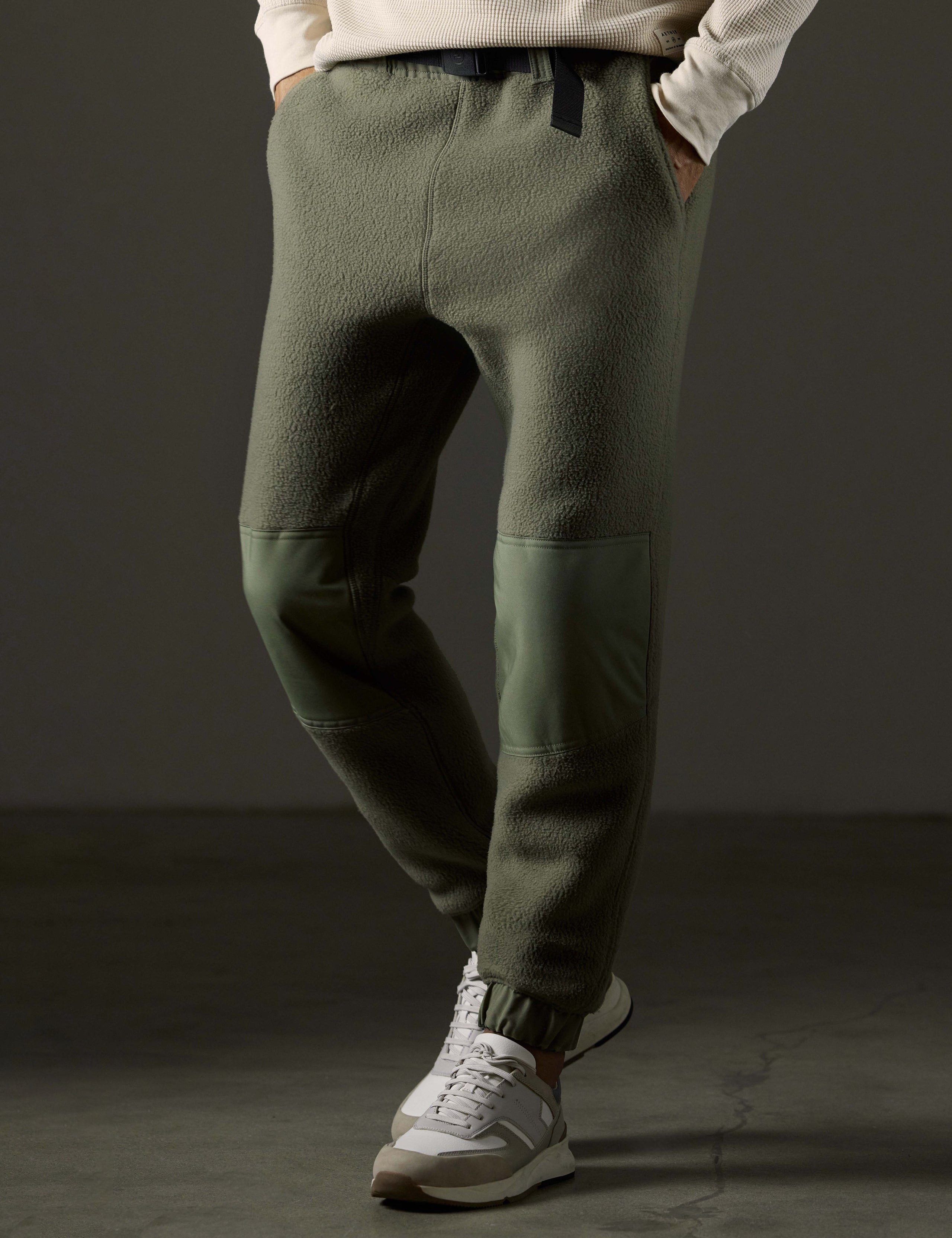 Front 3/4 body view of man wearing Walsh Pant in Fern Green from AETHER Apparel.