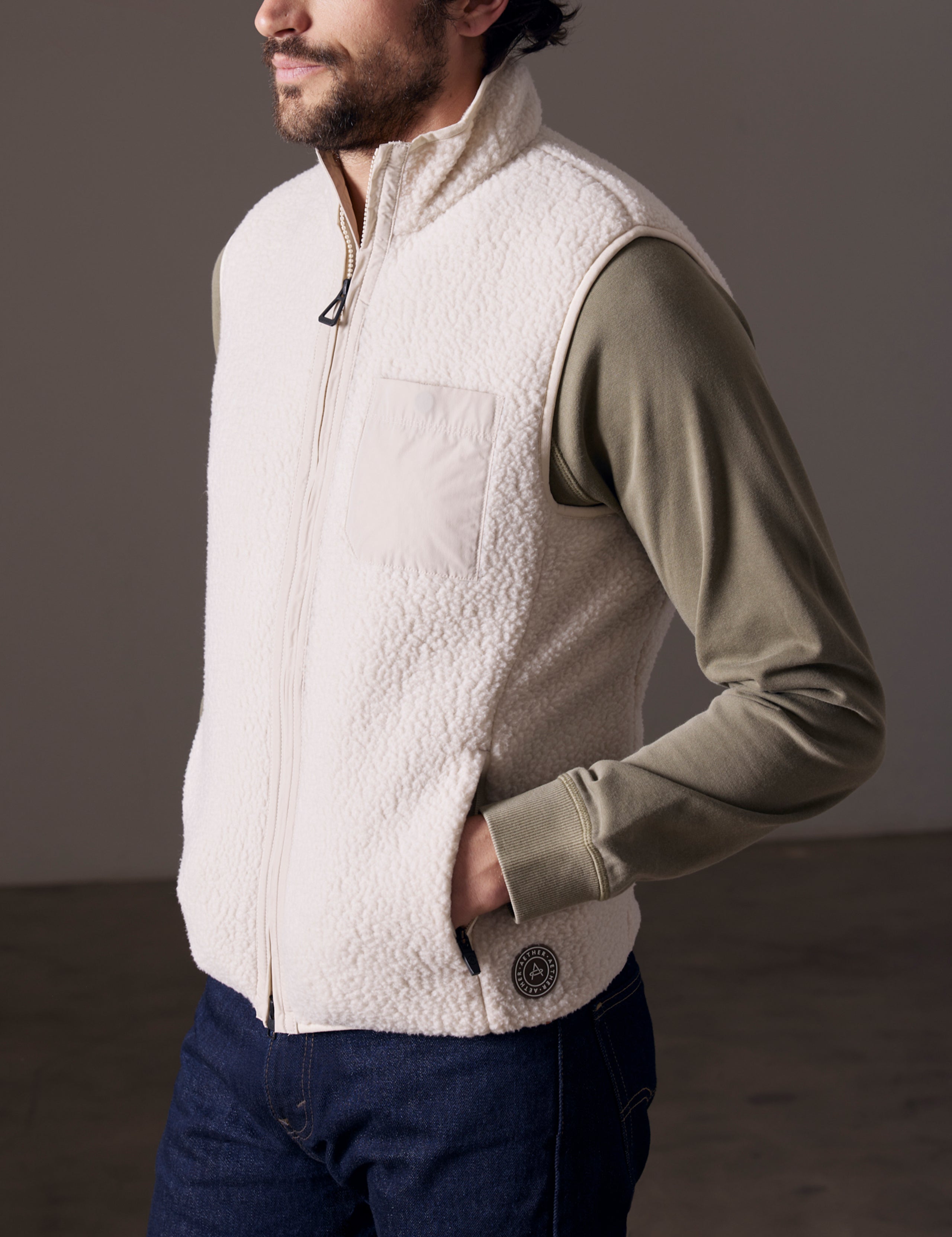 Front 3/4 body view of man wearing Walsh Vest in Bone white from AETHER Apparel.