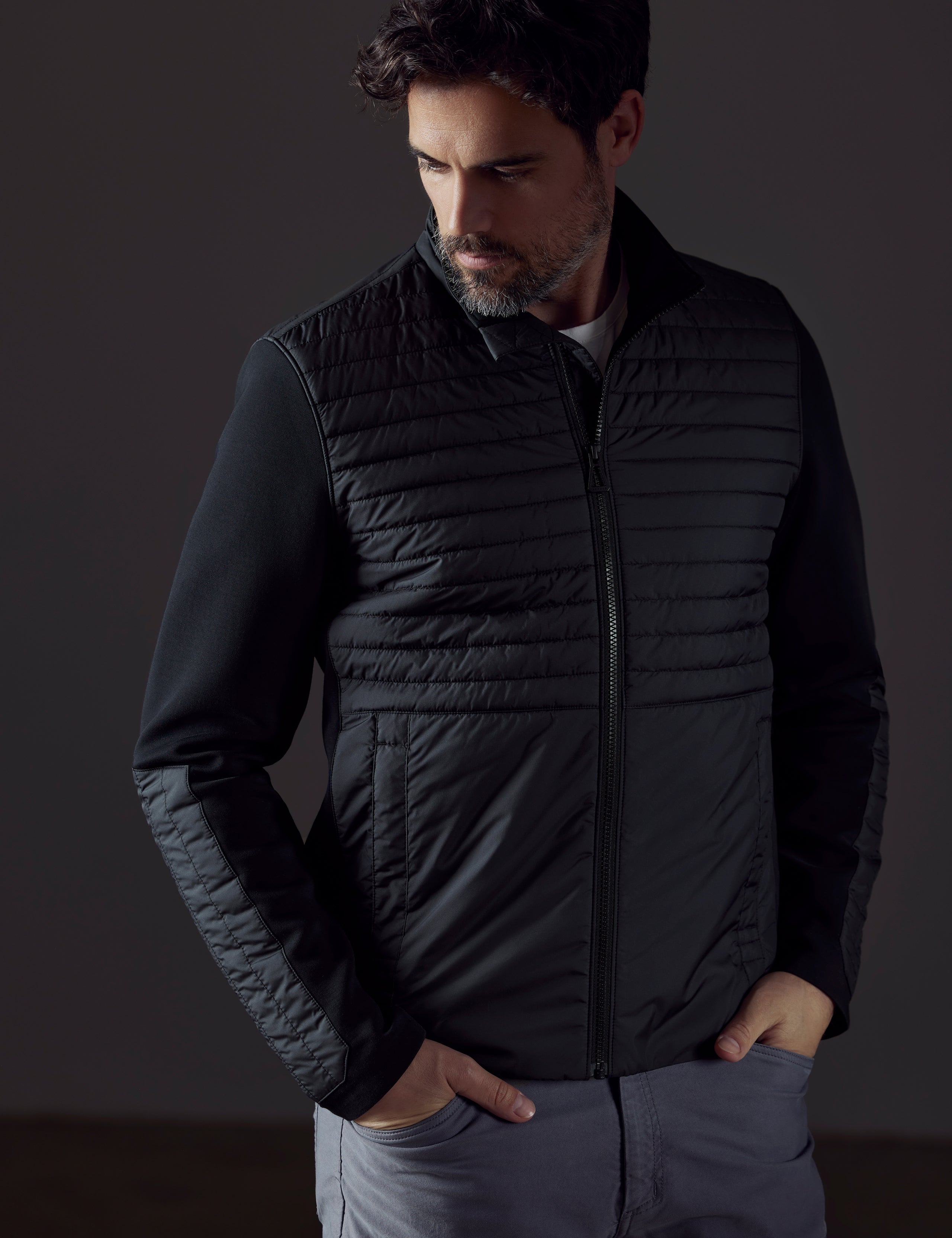 Front body view of man wearing Watts Technical Jacket in Onyx Black from AETHER Apparel.