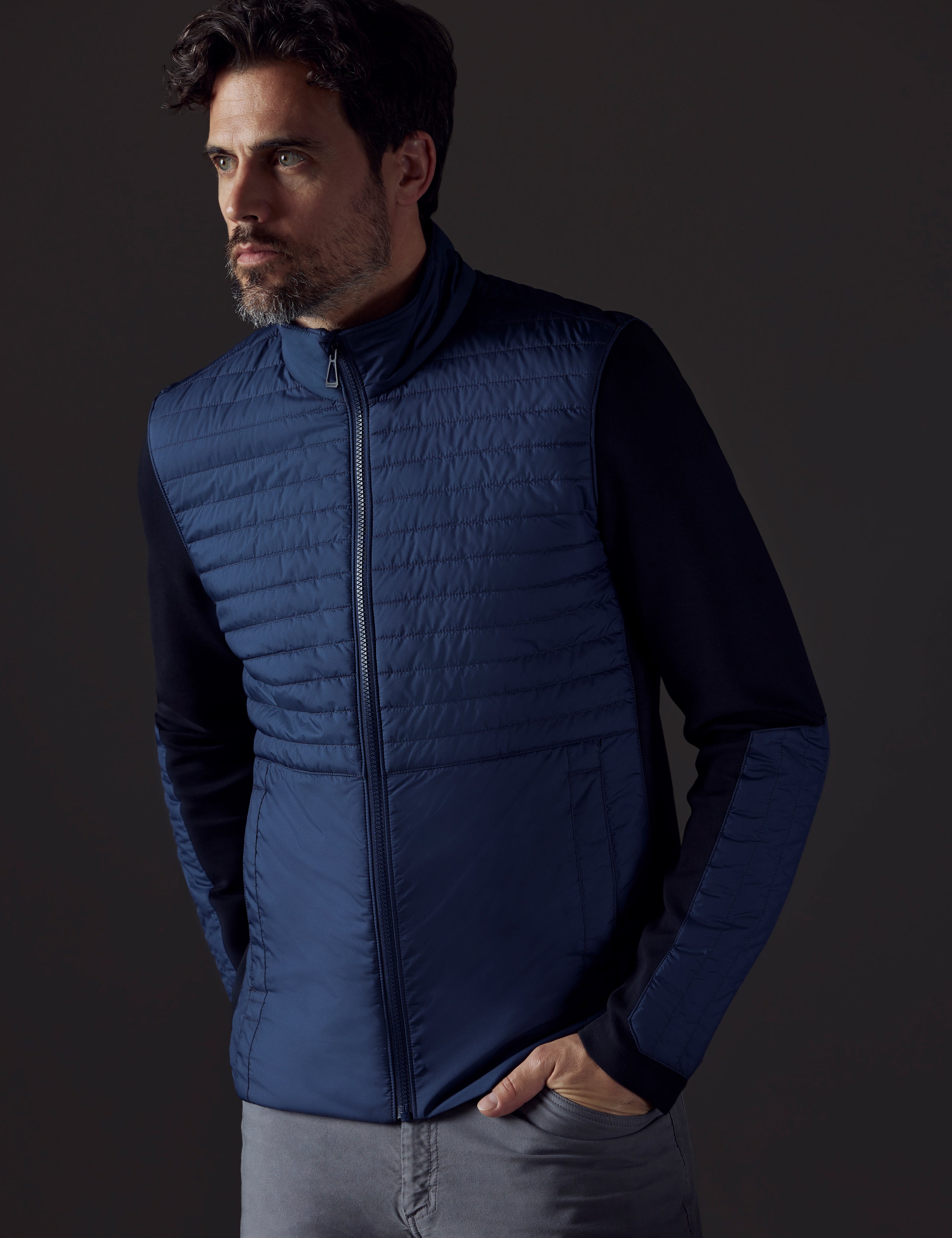 Front body view of man wearing Watts Technical Jacket in Total Eclipse dark blue from AETHER Apparel.