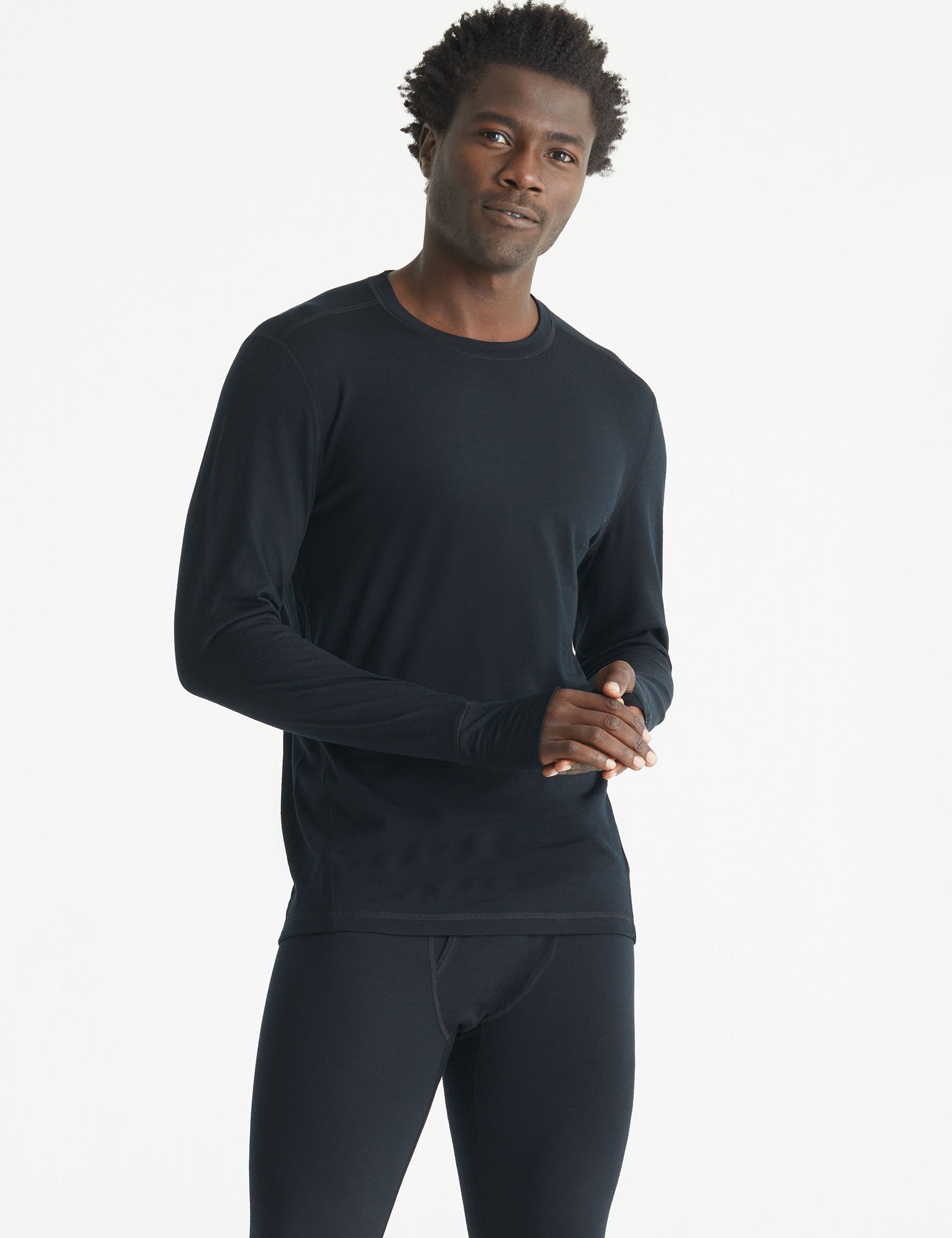 Front body view of man wearing Premium Merino Base Layer Crew in Jet Black from AETHER Apparel.