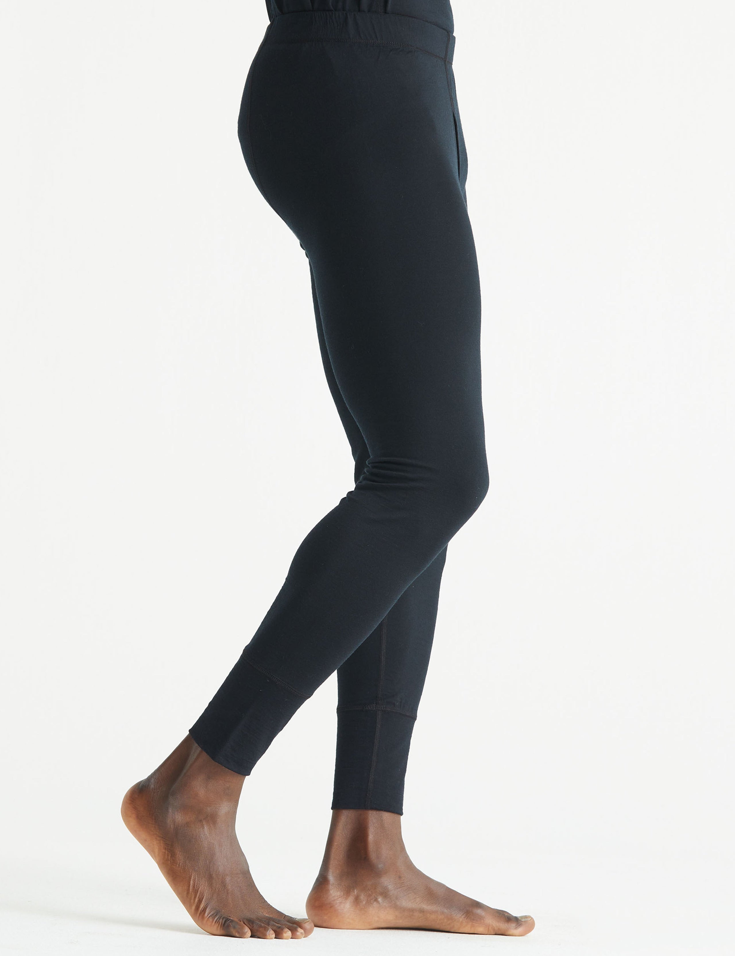 Side profile lower body view of man wearing Premium Merino Base Layer Pant in Jet Black from AETHER Apparel.