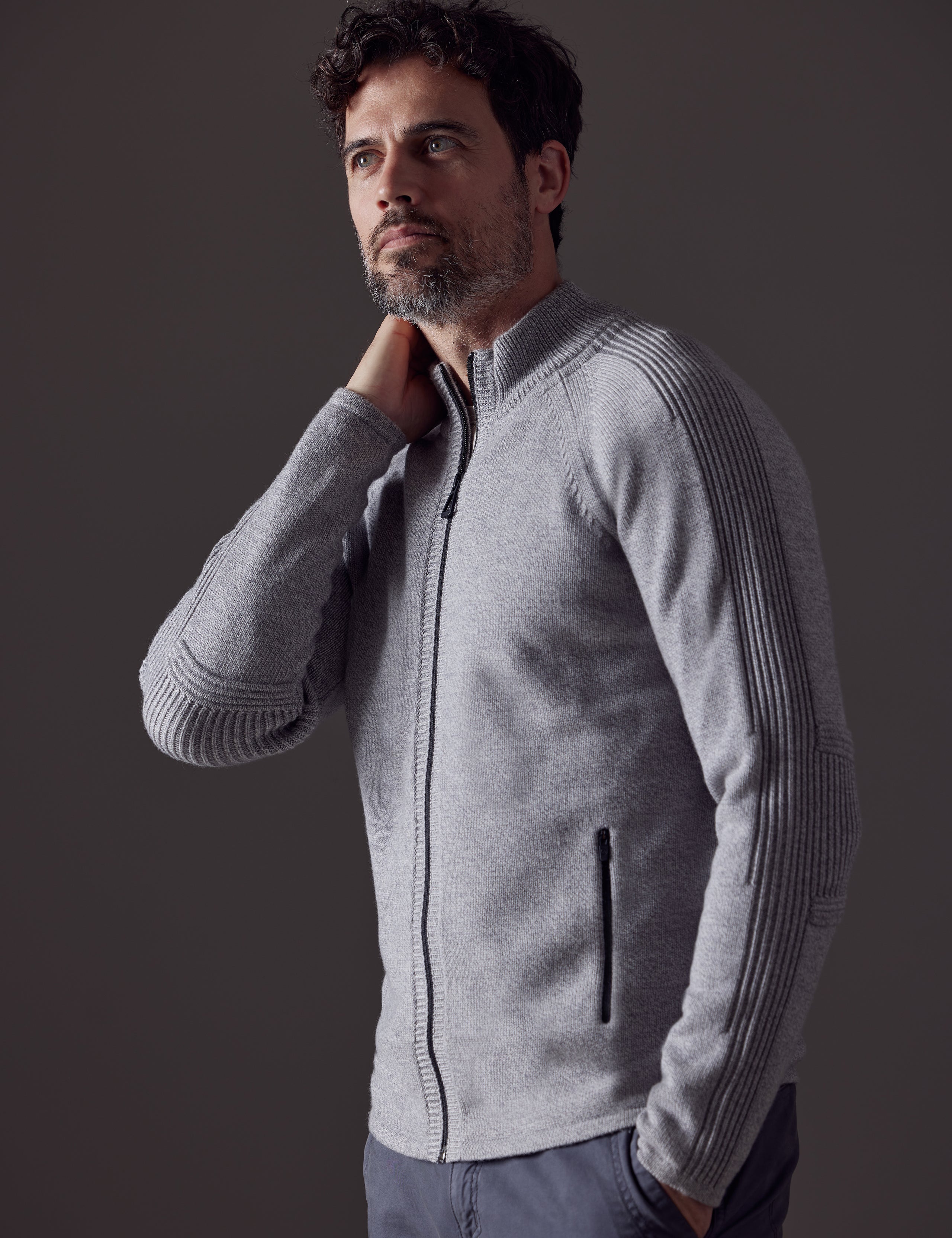 Front 3/4 body view of man wearing Riley Full-Zip Sweater in Light Heather Grey from AETHER Apparel.