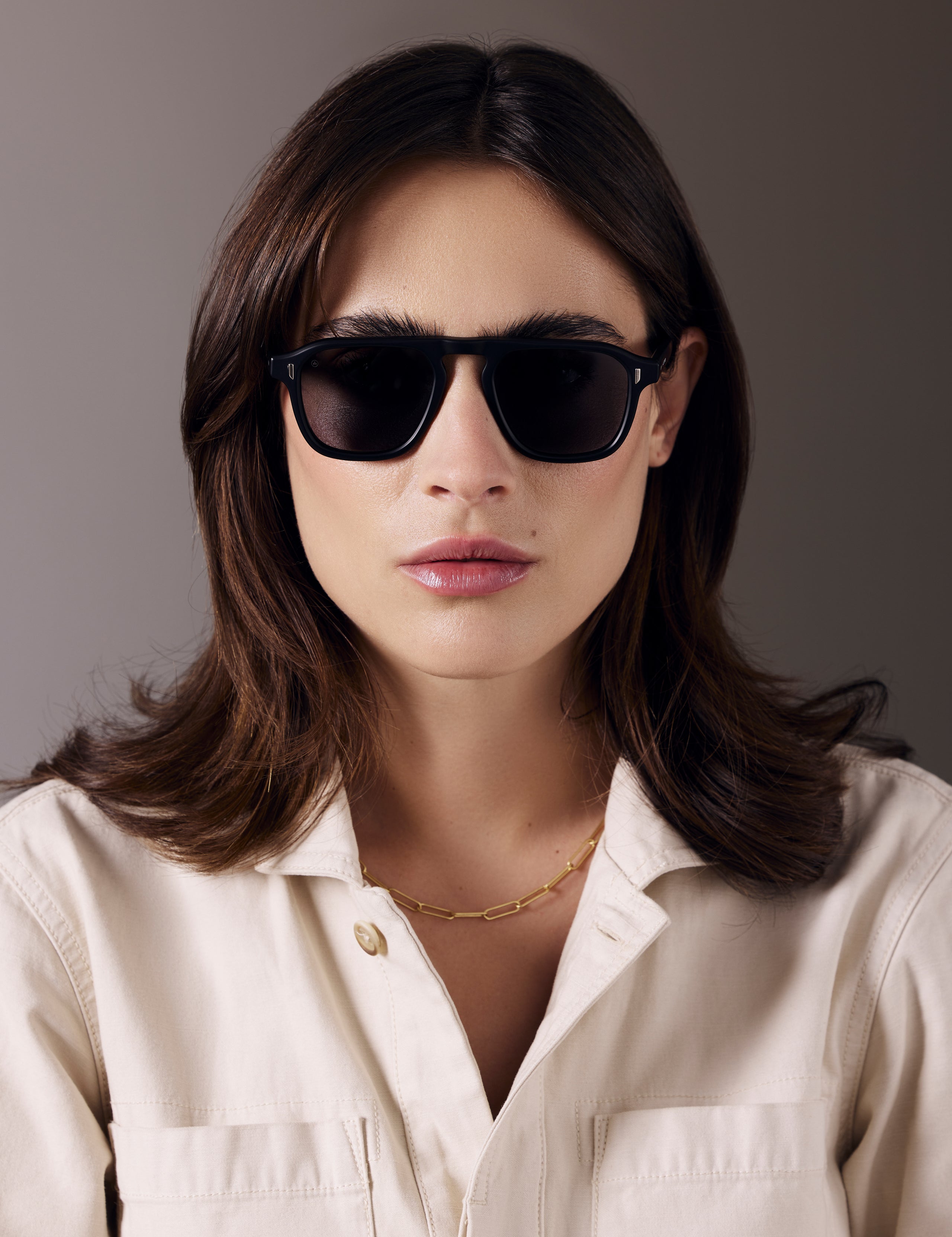 Front view of woman wearing Sequoia Sunglass in Matte Black with Grey Lens from AETHER Apparel.