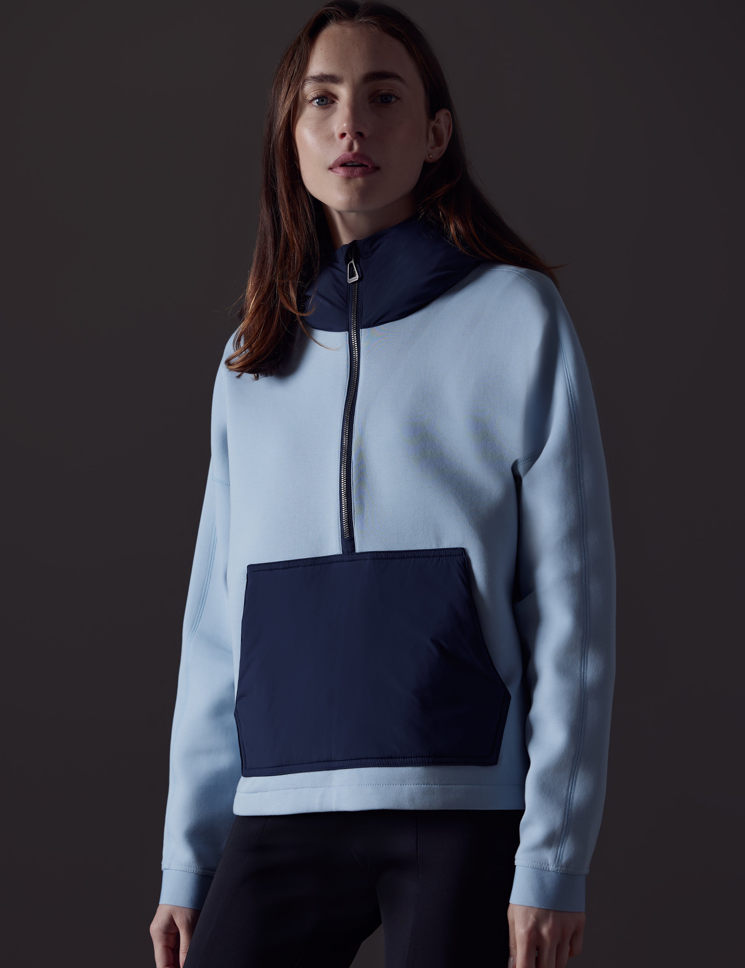 Front body view of woman wearing Align Hooded Anorak in Flight Blue from AETHER Apparel.