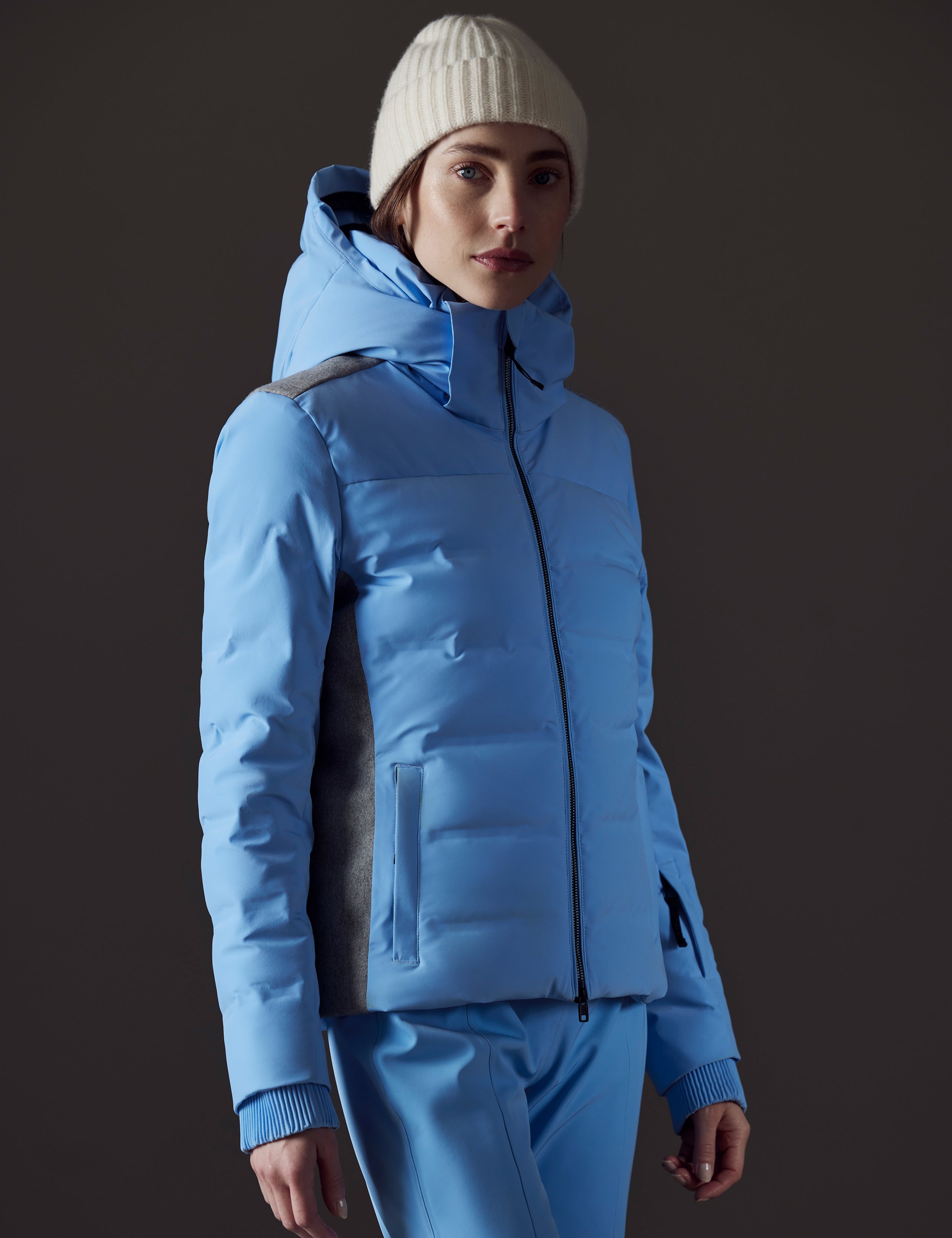 Front angled view of woman wearing Bancroft Snow Jacket in Atlas Blue from AETHER Apparel.
