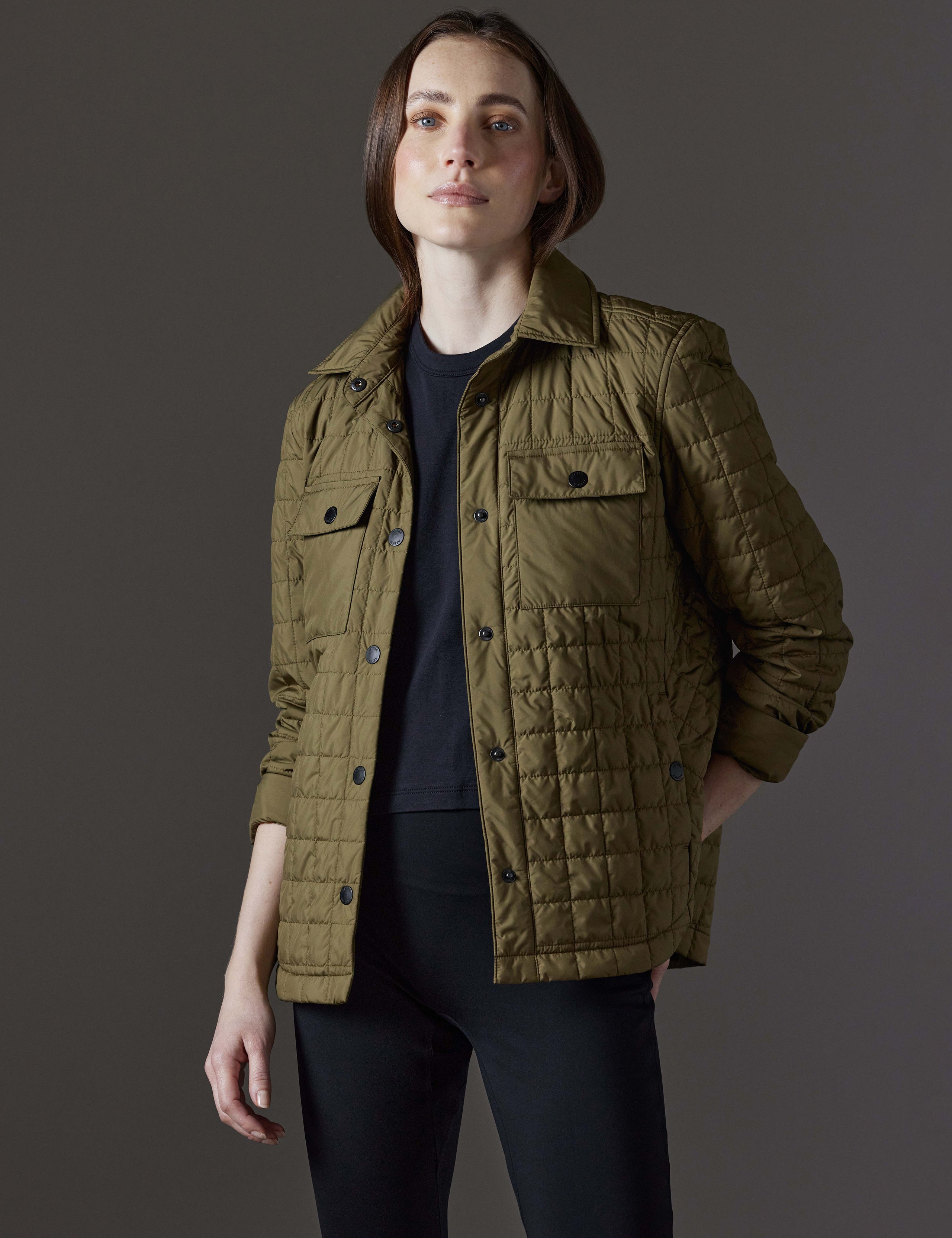 Front angled view of woman wearing Bardo Shirt Jacket in Command Green from AETHER Apparel.