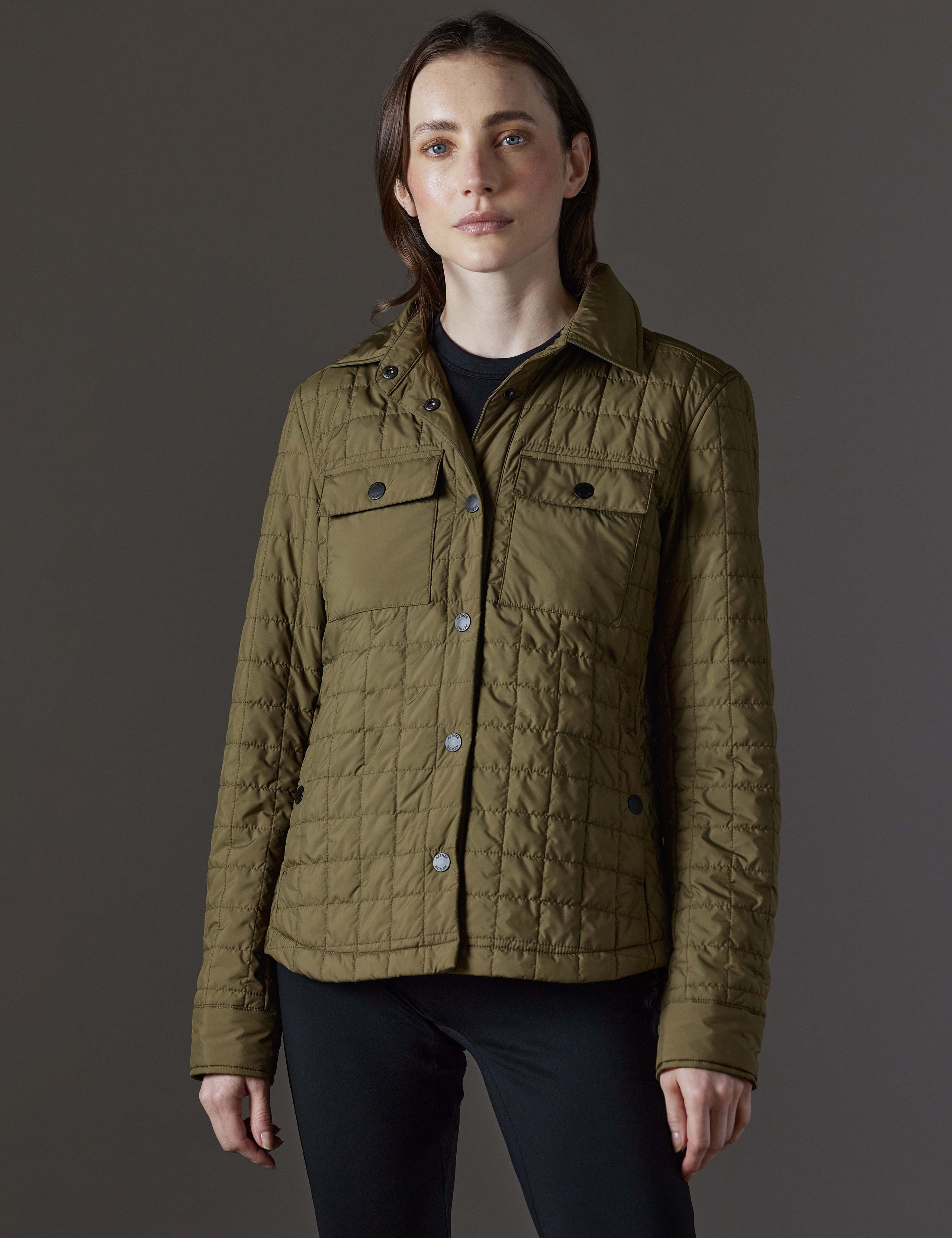 Front view of woman wearing Bardo Shirt Jacket in Command Green from AETHER Apparel.