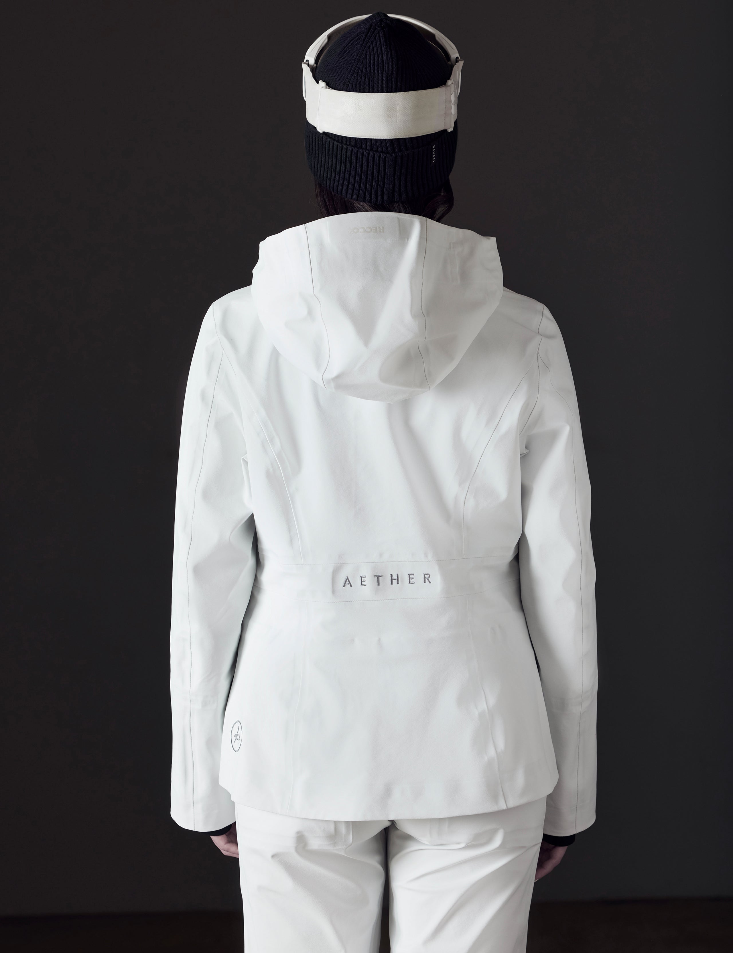 Rear view of woman wearing Boyd Snow Jacket in White from AETHER Apparel.