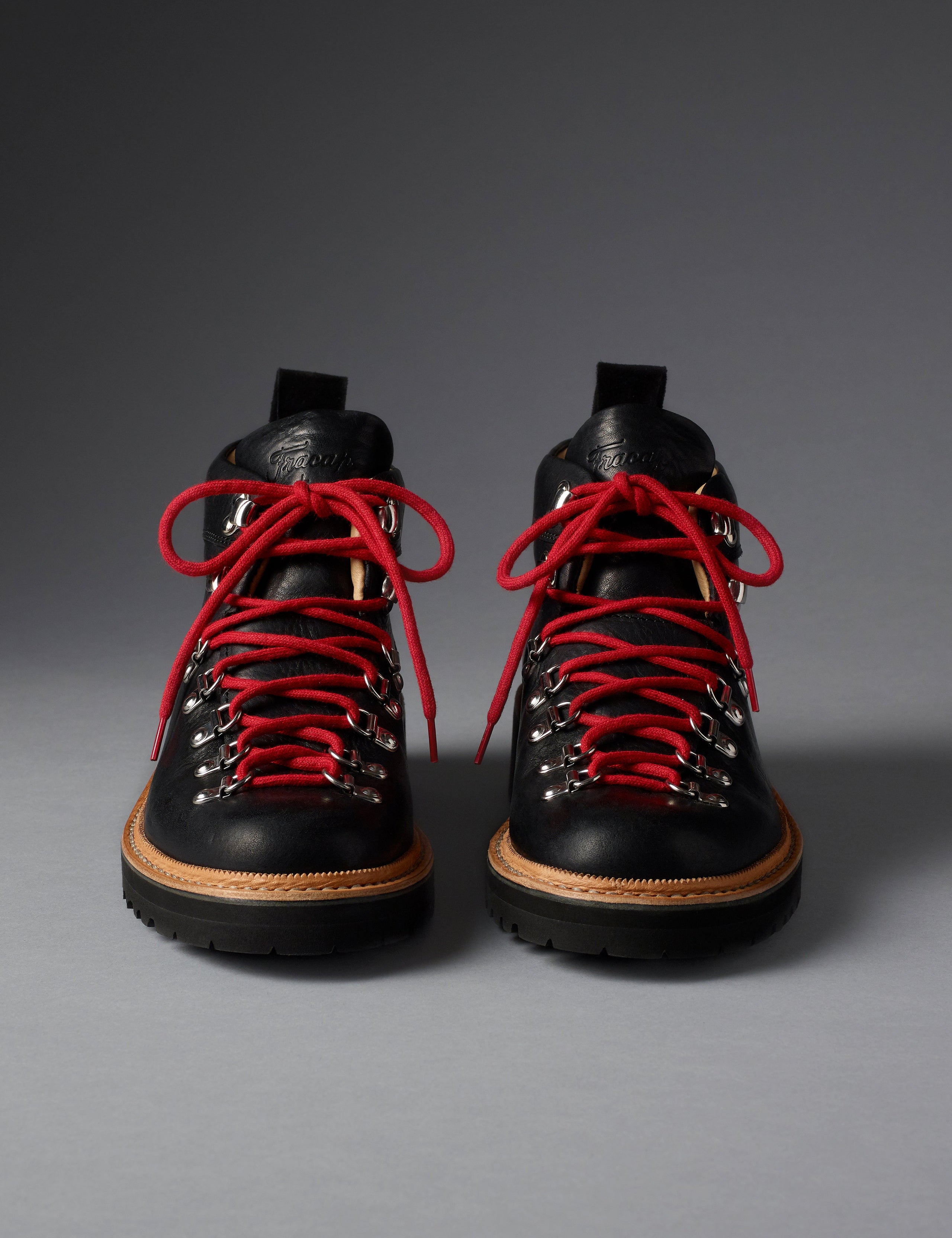 Front view of women’s Dolomite Boot in Onyx Black from AETHER Apparel with red laces. 