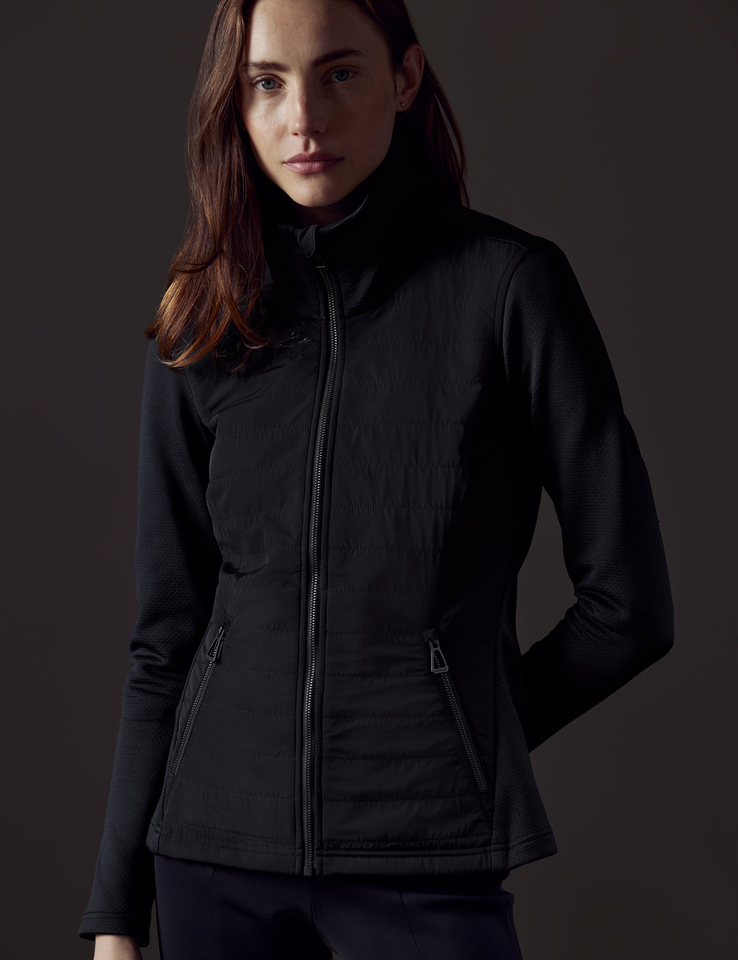 Front body view of woman wearing Morgan Technical Full-Zip in Onyx Black from AETHER Apparel.