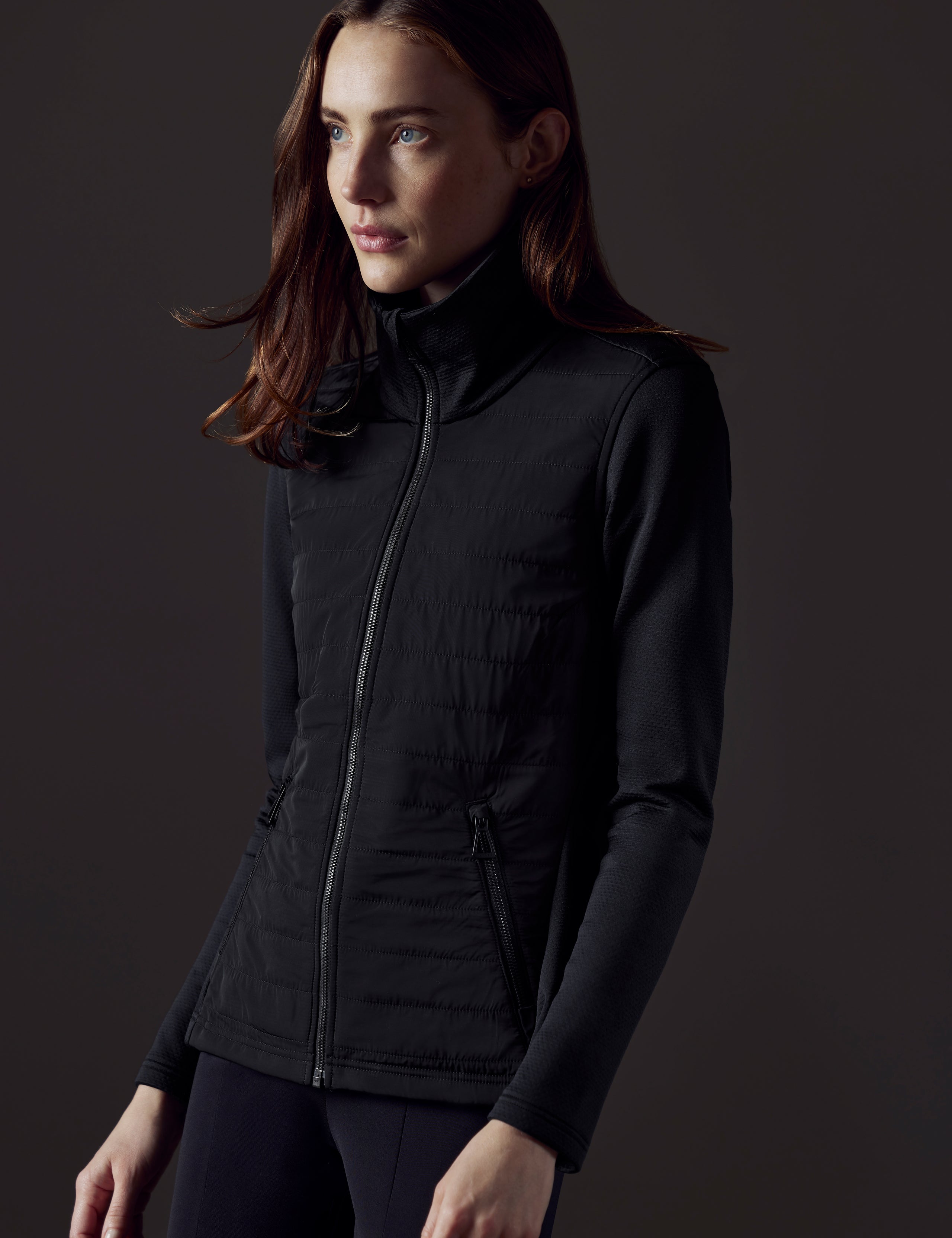 Front 3/4 body view of woman wearing Morgan Technical Full-Zip in Onyx Black from AETHER Apparel.