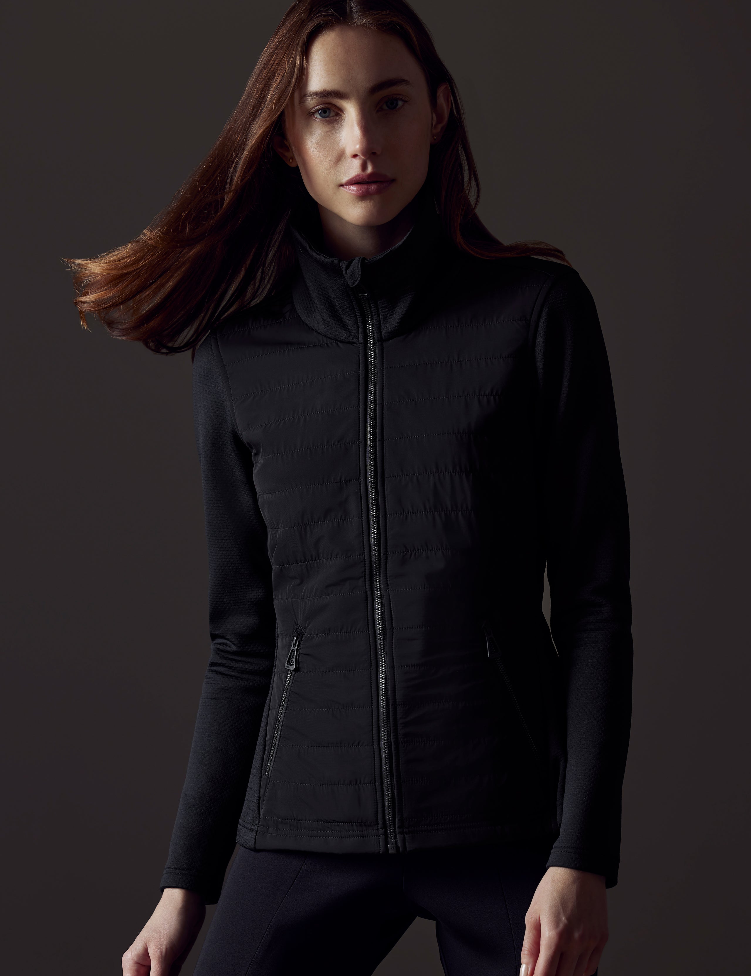 Front body view of woman wearing Morgan Technical Full-Zip in Onyx Black from AETHER Apparel.