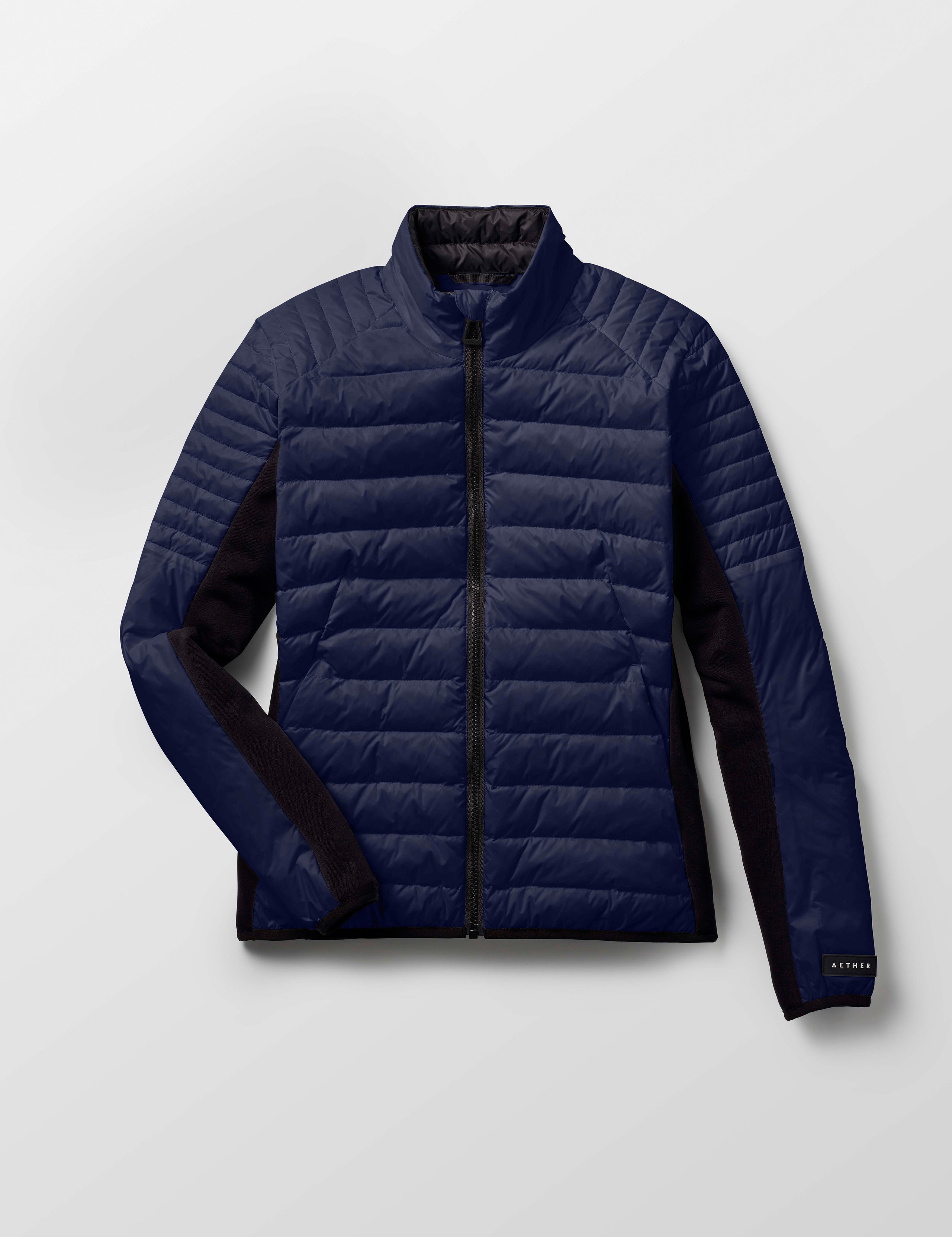 Flat lay of women's Ozone Jacket in Nordic Navy blue from AETHER Apparel.