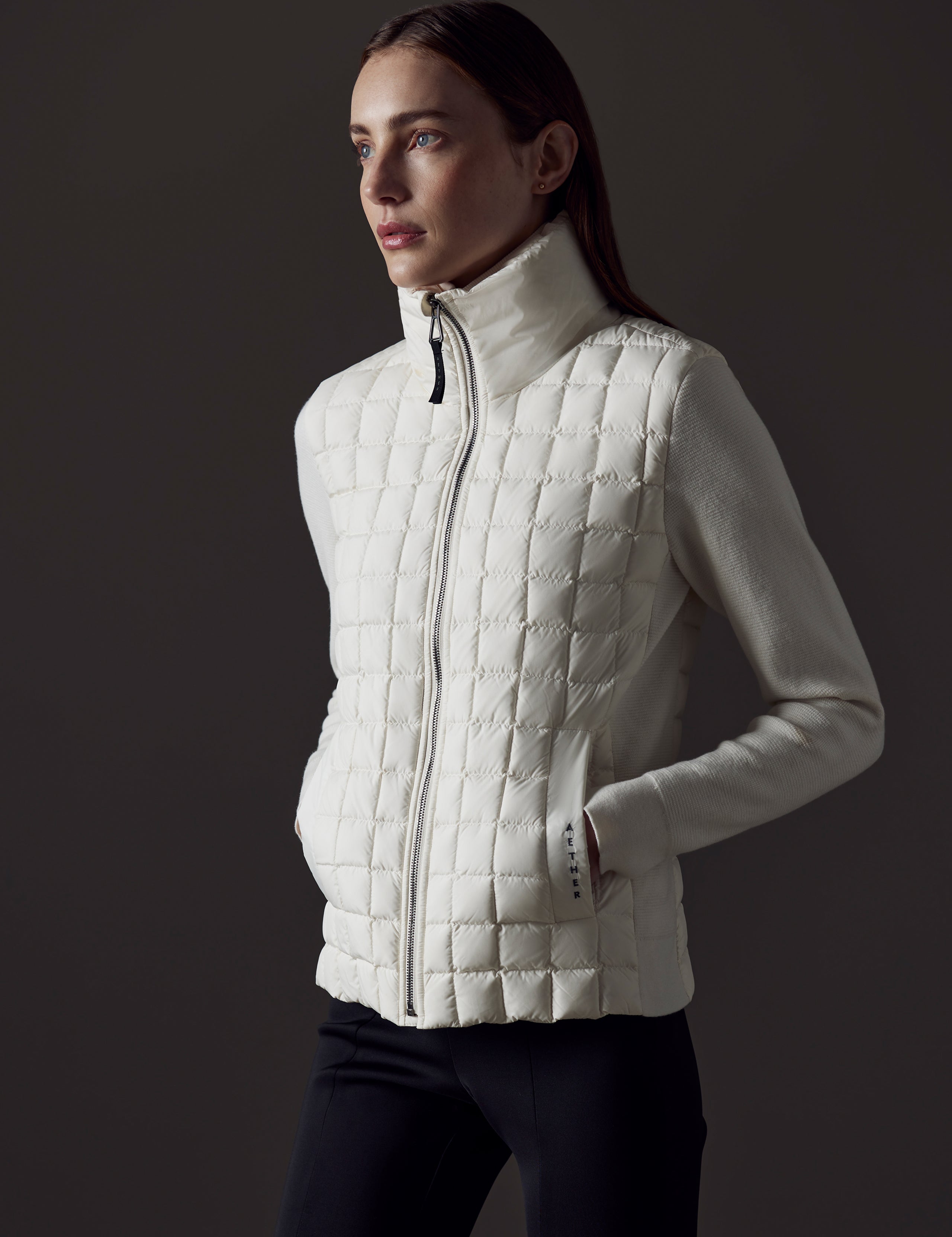 Front angled view of woman wearing Phase Full-Zip in Winter White from AETHER Apparel.