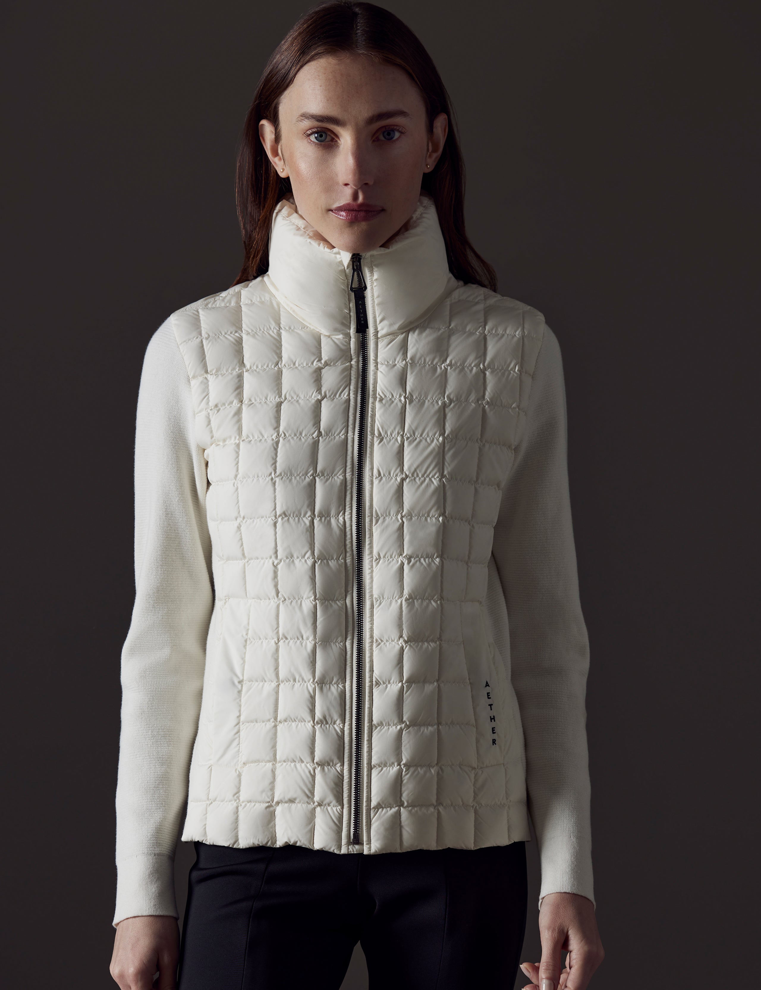 Front view of woman wearing Phase Full-Zip in Winter White from AETHER Apparel.