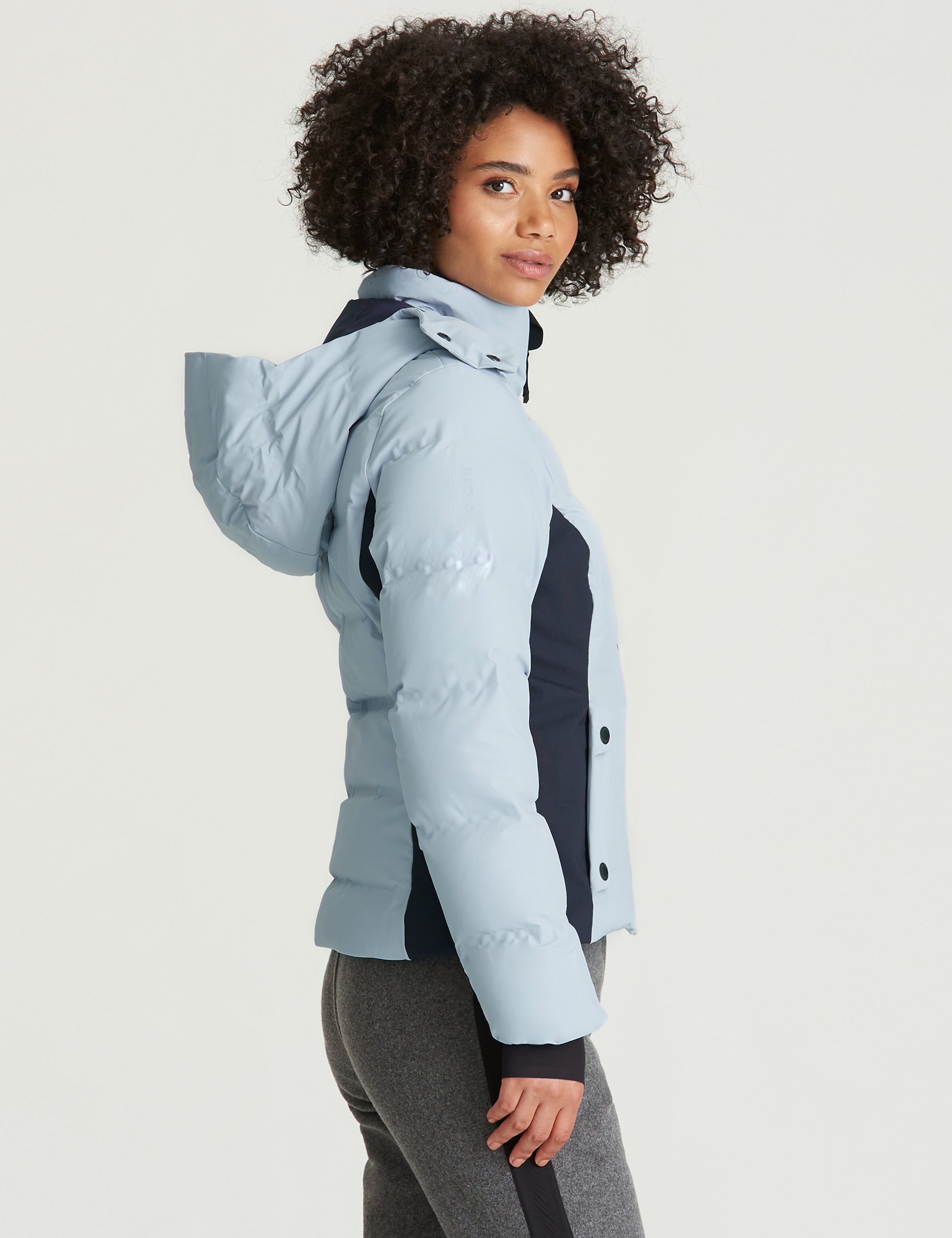Side profile view of woman wearing Torino Jacket in Vista Blue from AETHER Apparel.