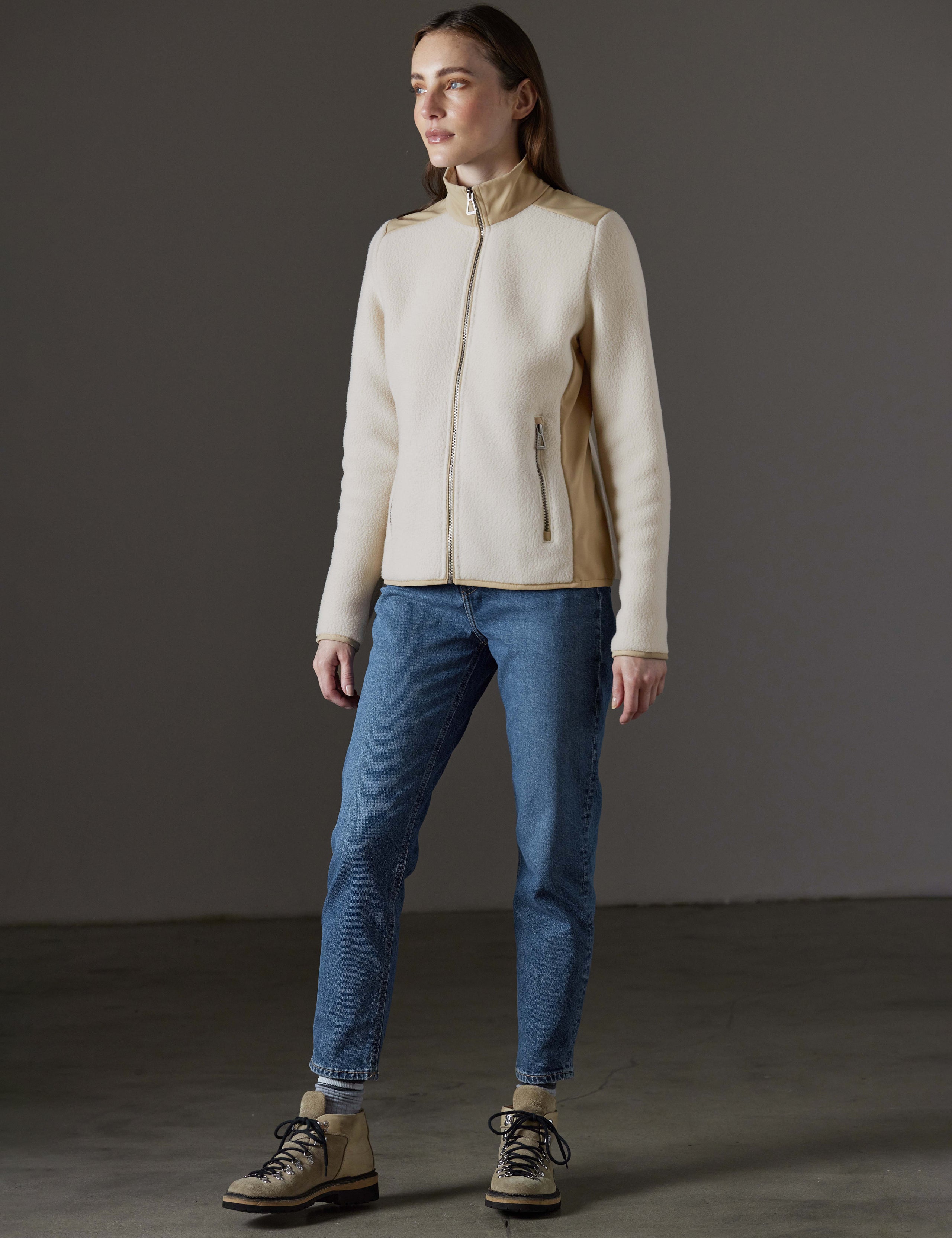 Front angled full-body view of woman wearing Walsh Full-Zip 2.0 in Bone and Desert Tan from AETHER Apparel.