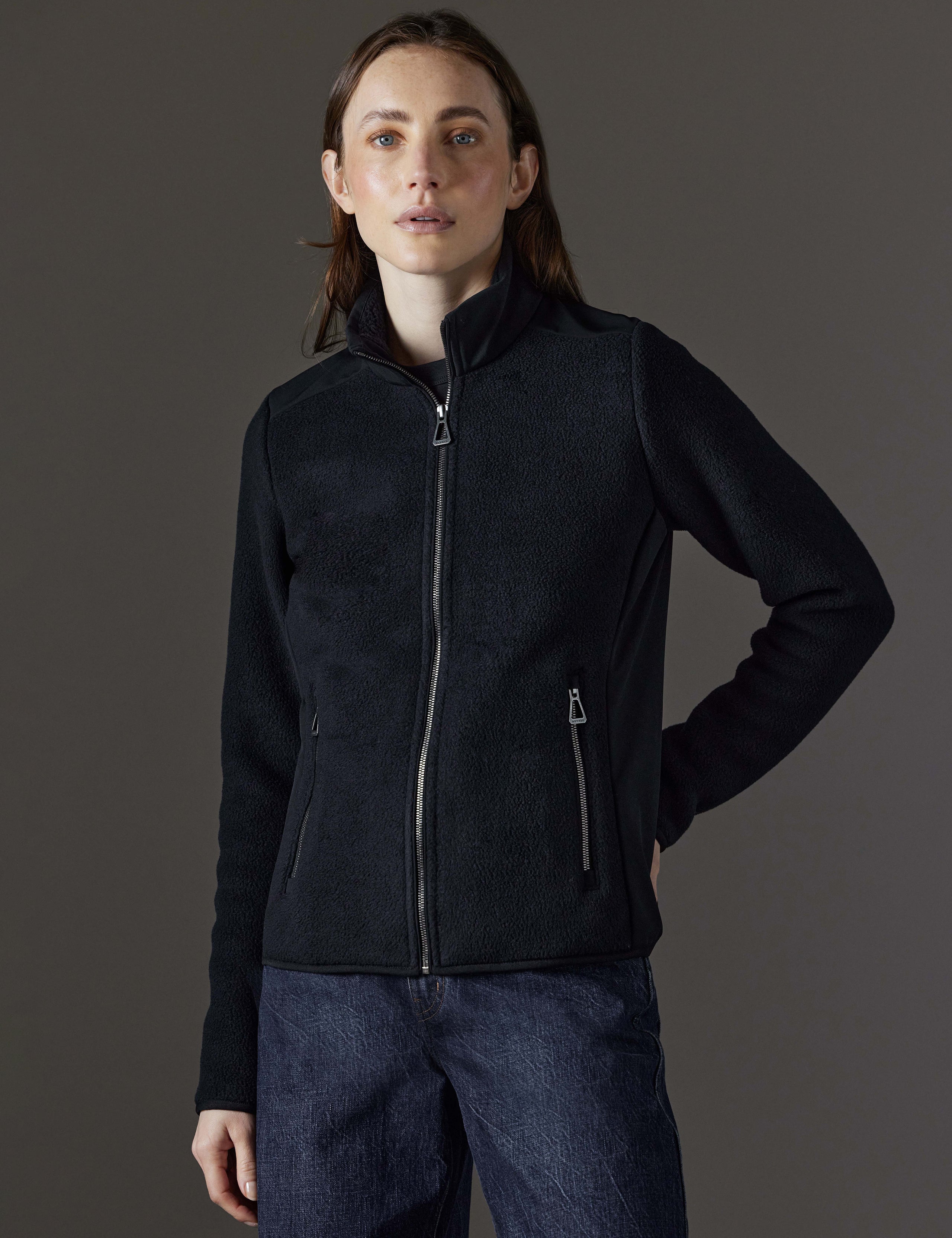 Front body view of woman wearing Walsh Full-Zip 2.0 in Onyx Black from AETHER Apparel.