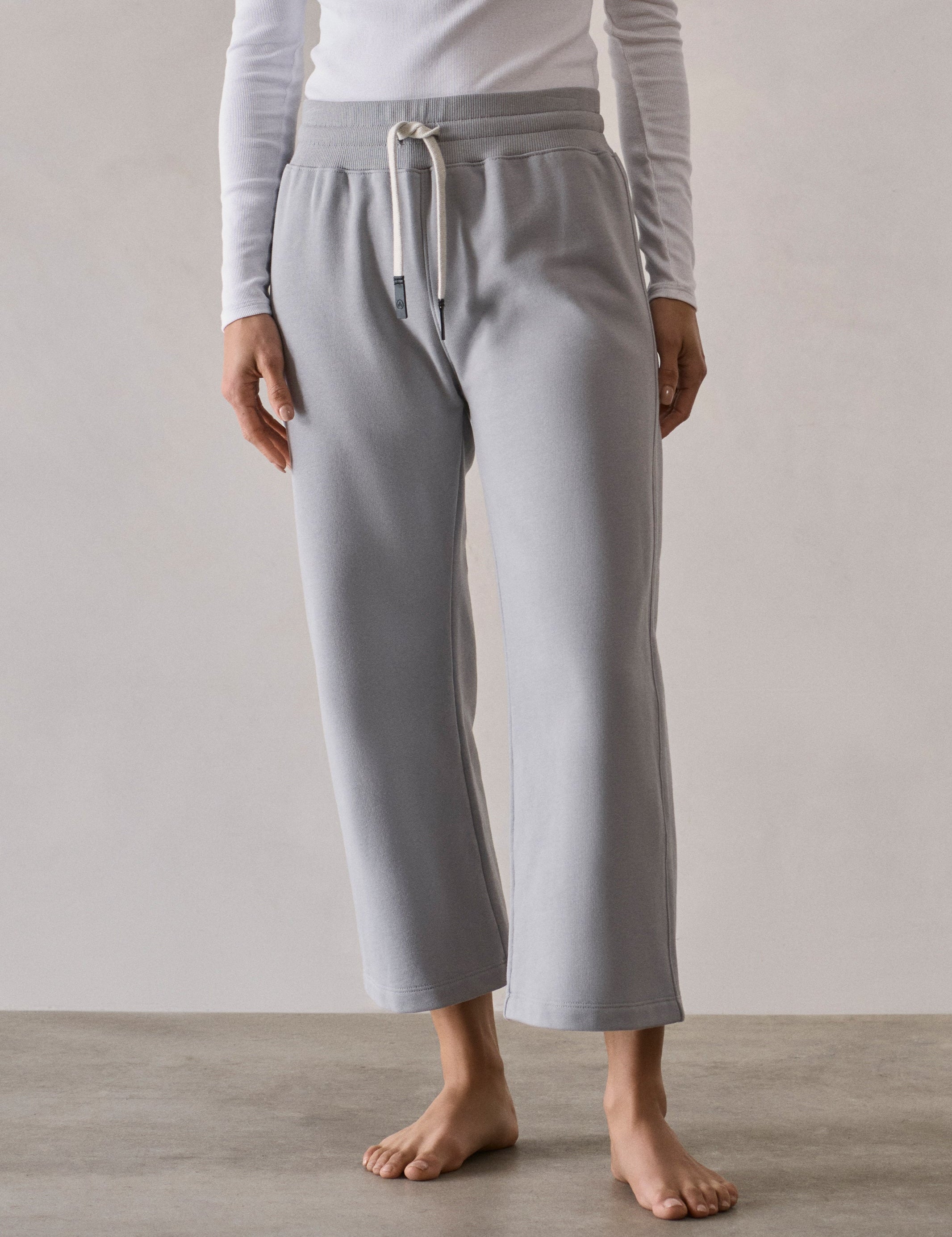 Front full-body view of woman wearing W Osa Cropped Sweatpant in Sky Grey from AETHER Apparel.